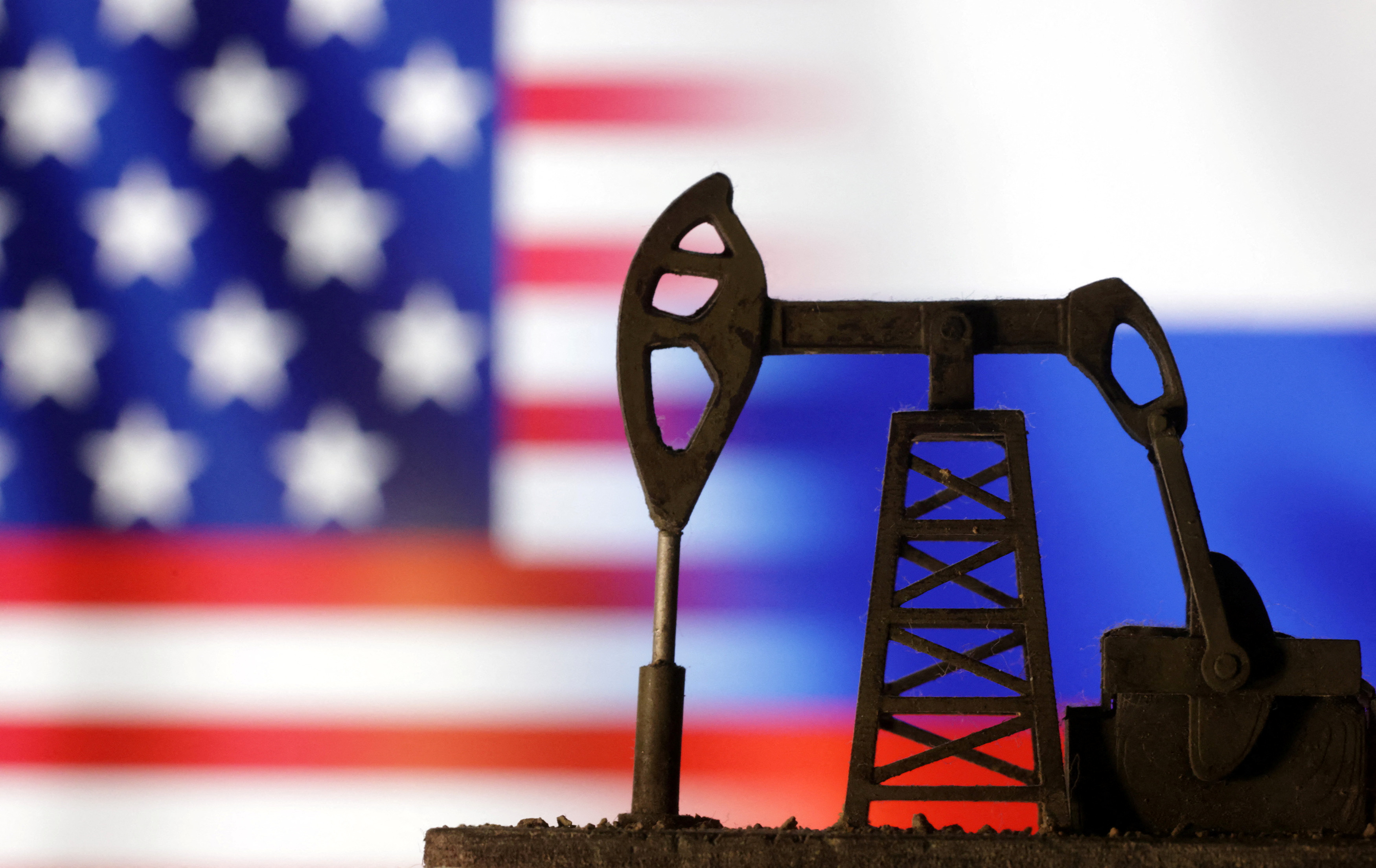 Illustration shows Oil pump jack, U.S. and Russian flags