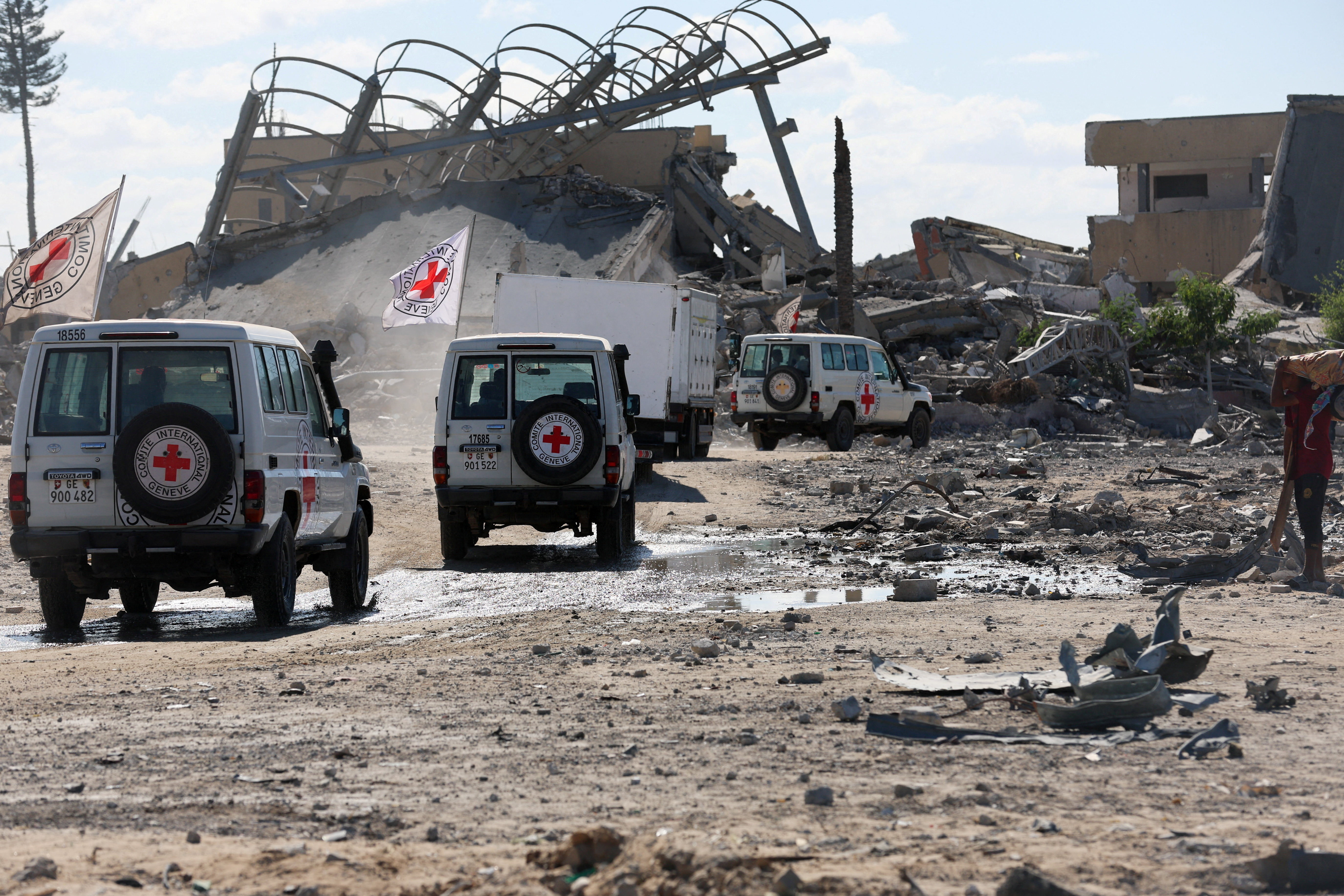 Red Cross vehicles escort a truck transporting the bodies of Palestinians who had been held in Israel during the war, in Khan Younis
