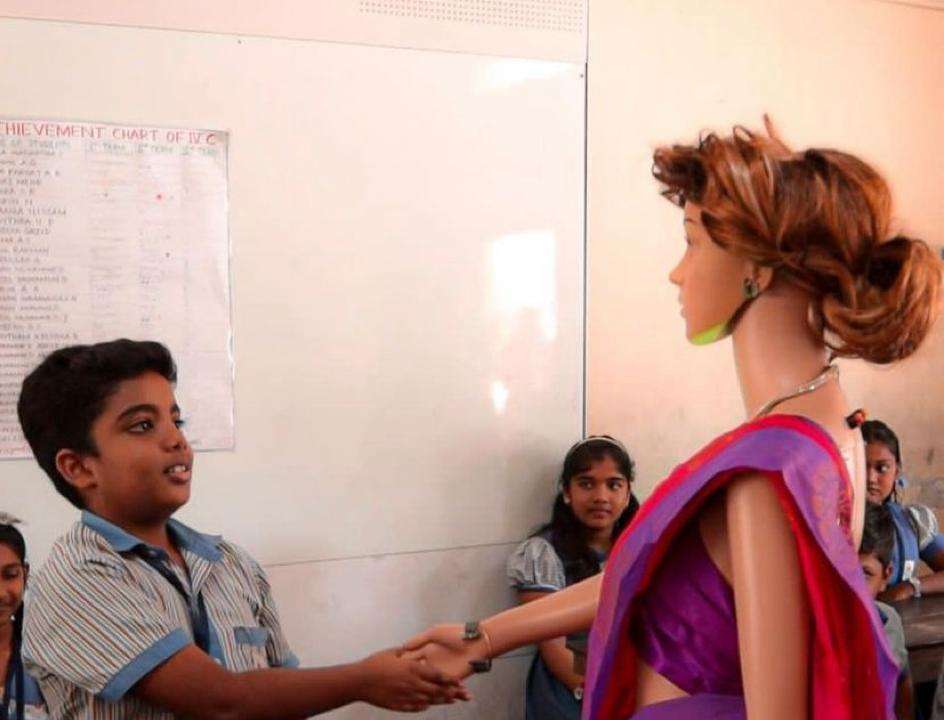 AI teacher robot Iris interacts with a student in the classroom