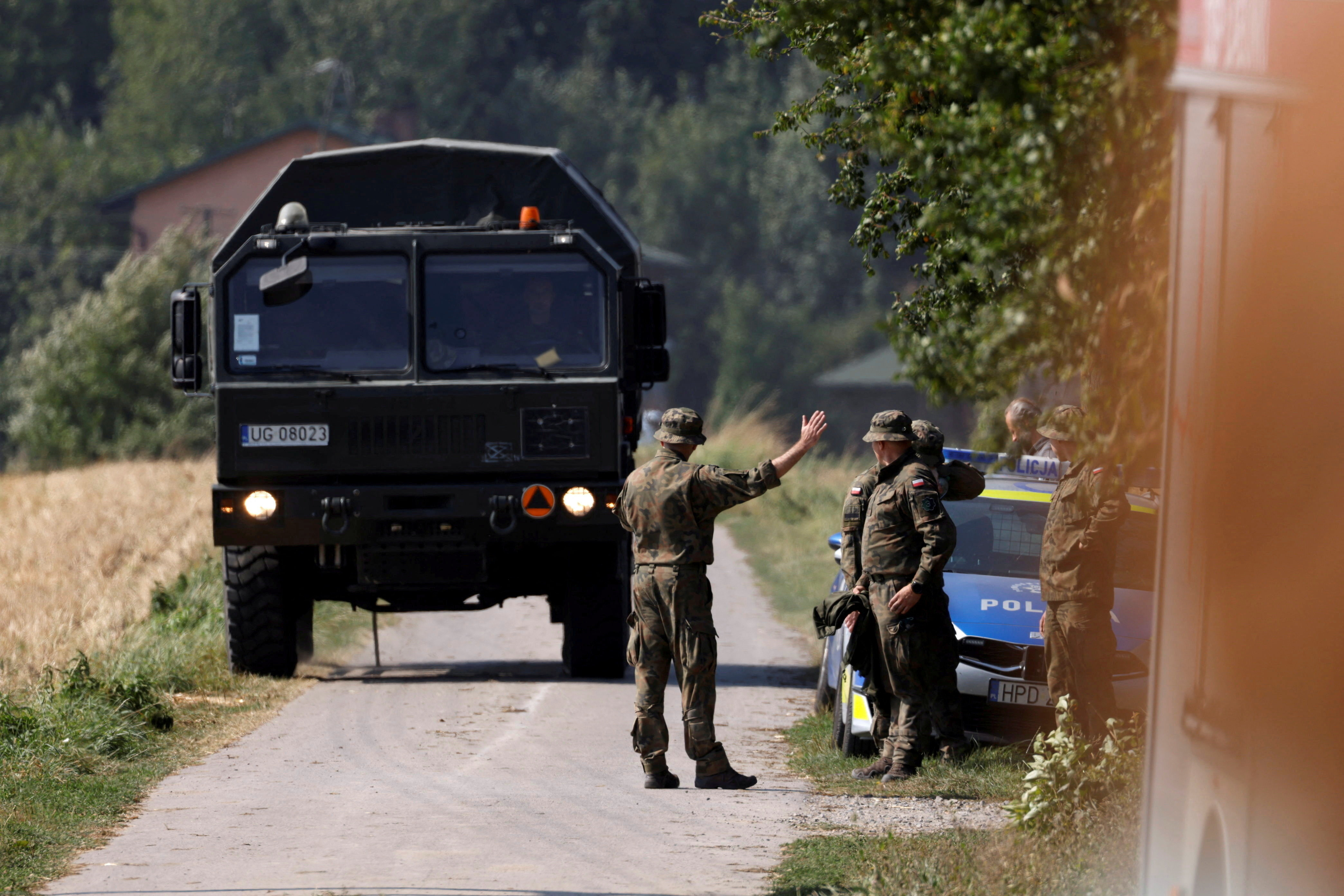 Soldiers stand guard near the site a Russian drone is believed to have fallen after intrusions into Polish airspace, in Czesniki