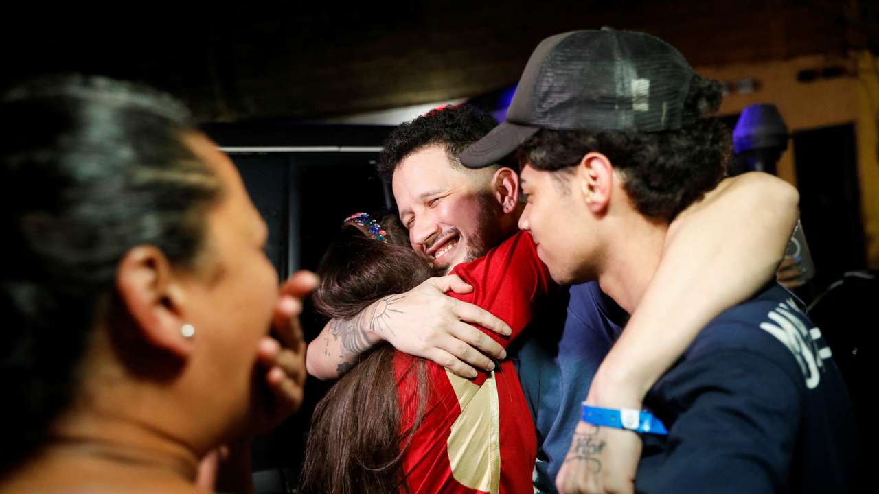Arturo Suarez, who was held for months in an El Salvador prison, greets family members after his release, in Caracas
