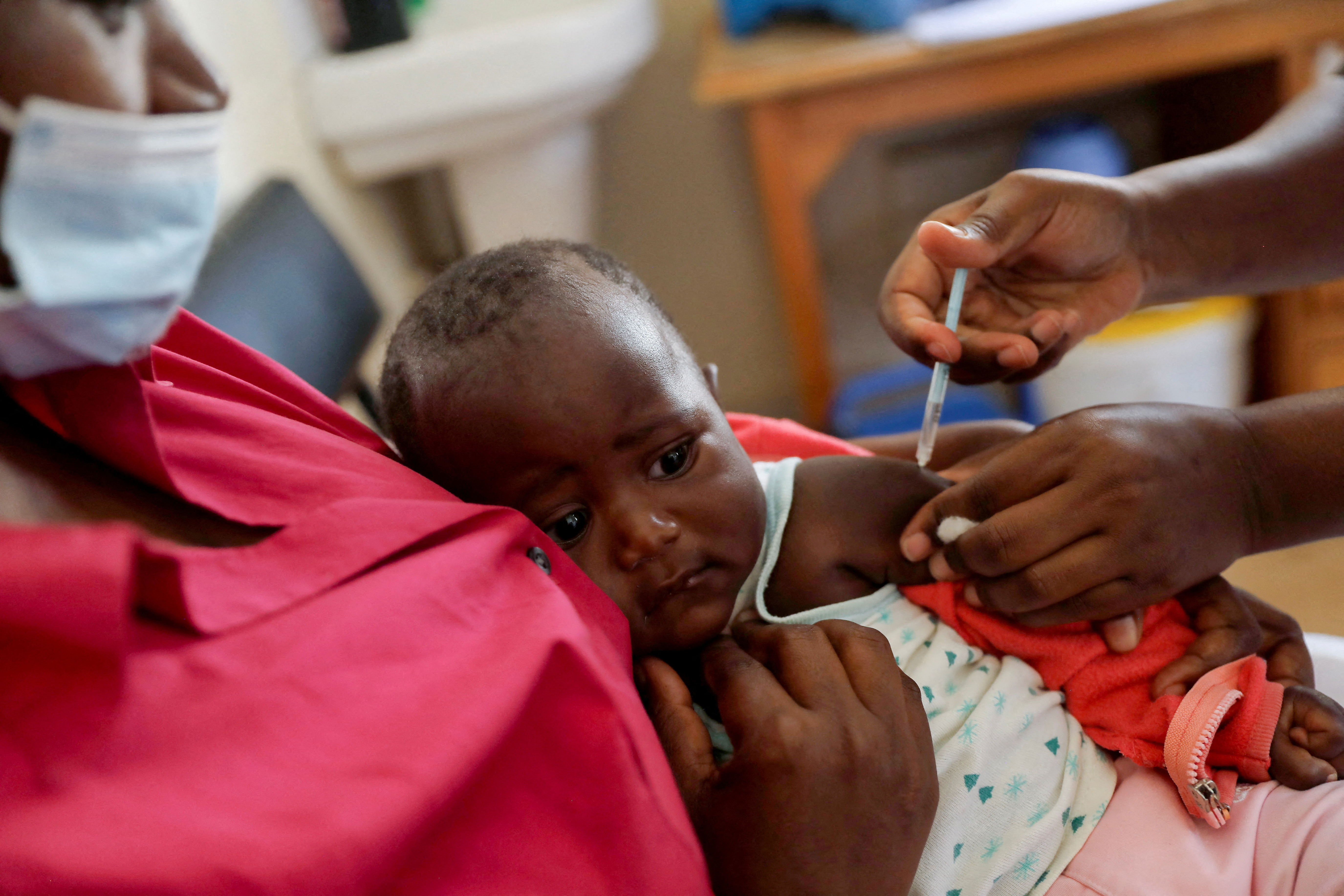 FILE PHOTO: A nurse administers the malaria vaccine to an infant at the Lumumba hospital in Kisumu