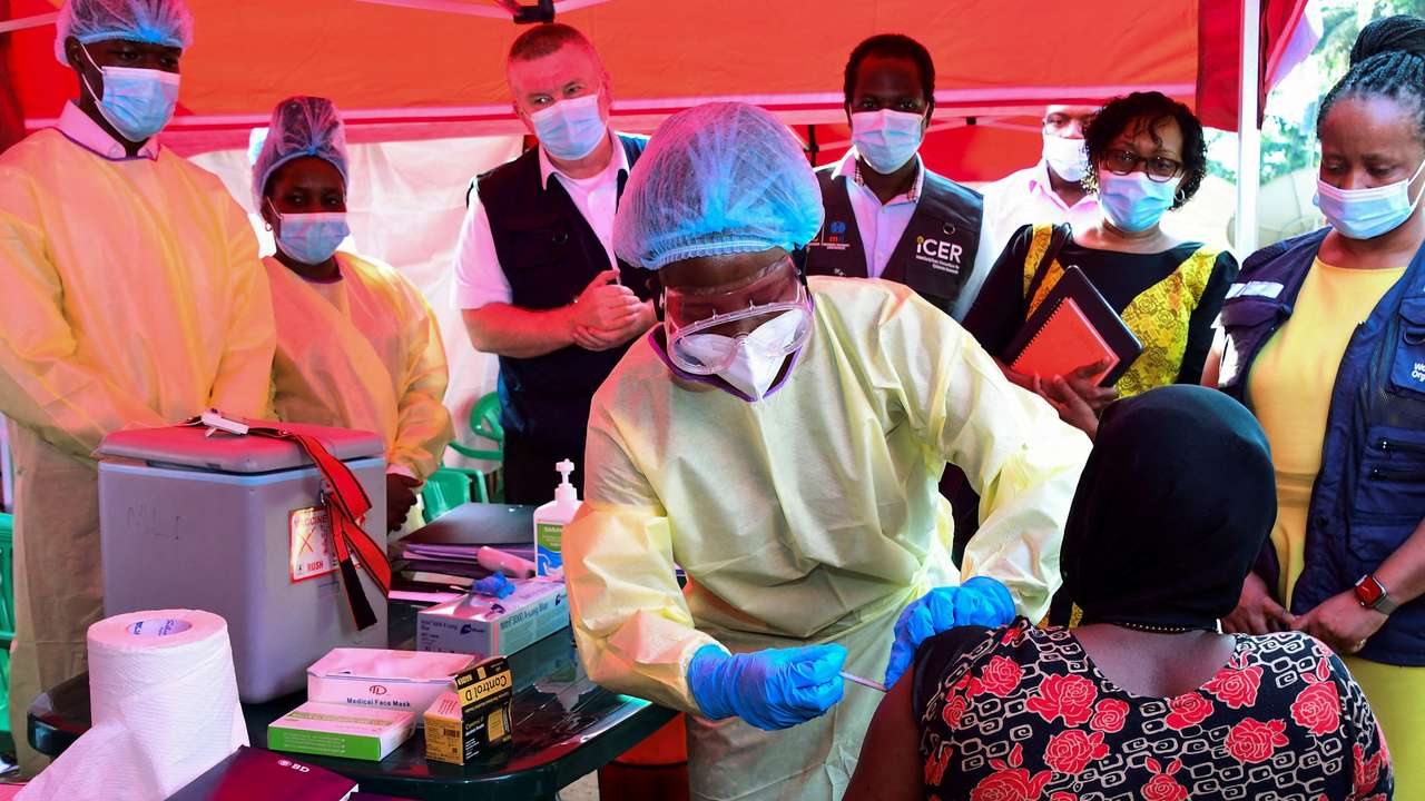 FILE PHOTO: A Ugandan doctor vaccinates the contact of a patient who tested positive during the launch of the vaccination for the Sudan strain of the Ebola virus, in Kampala