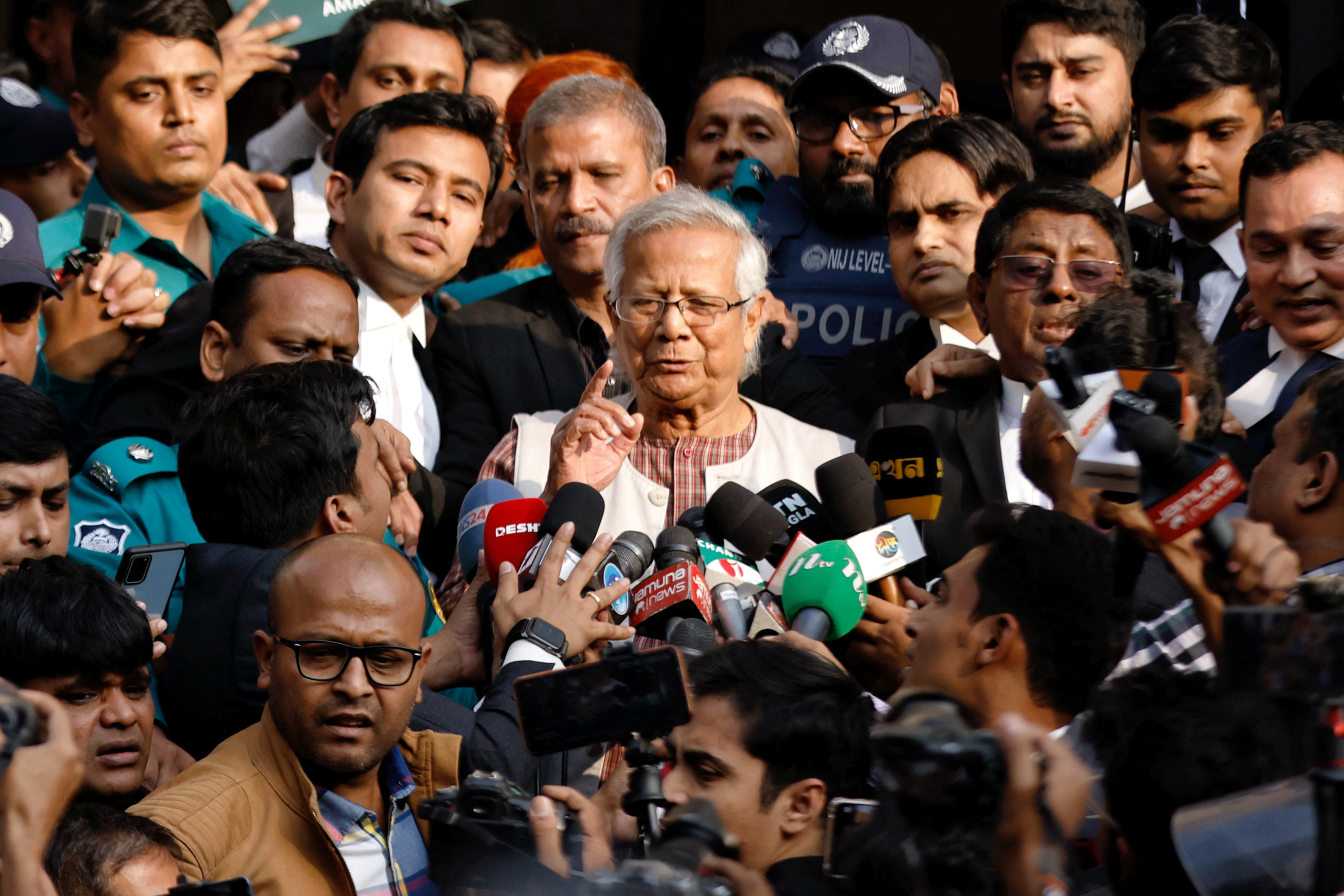 FILE PHOTO: Bangladeshi Nobel peace laureate Professor Muhammad Yunus gestures in front of the court after being sentenced for six months of imprisonment, in Dhaka