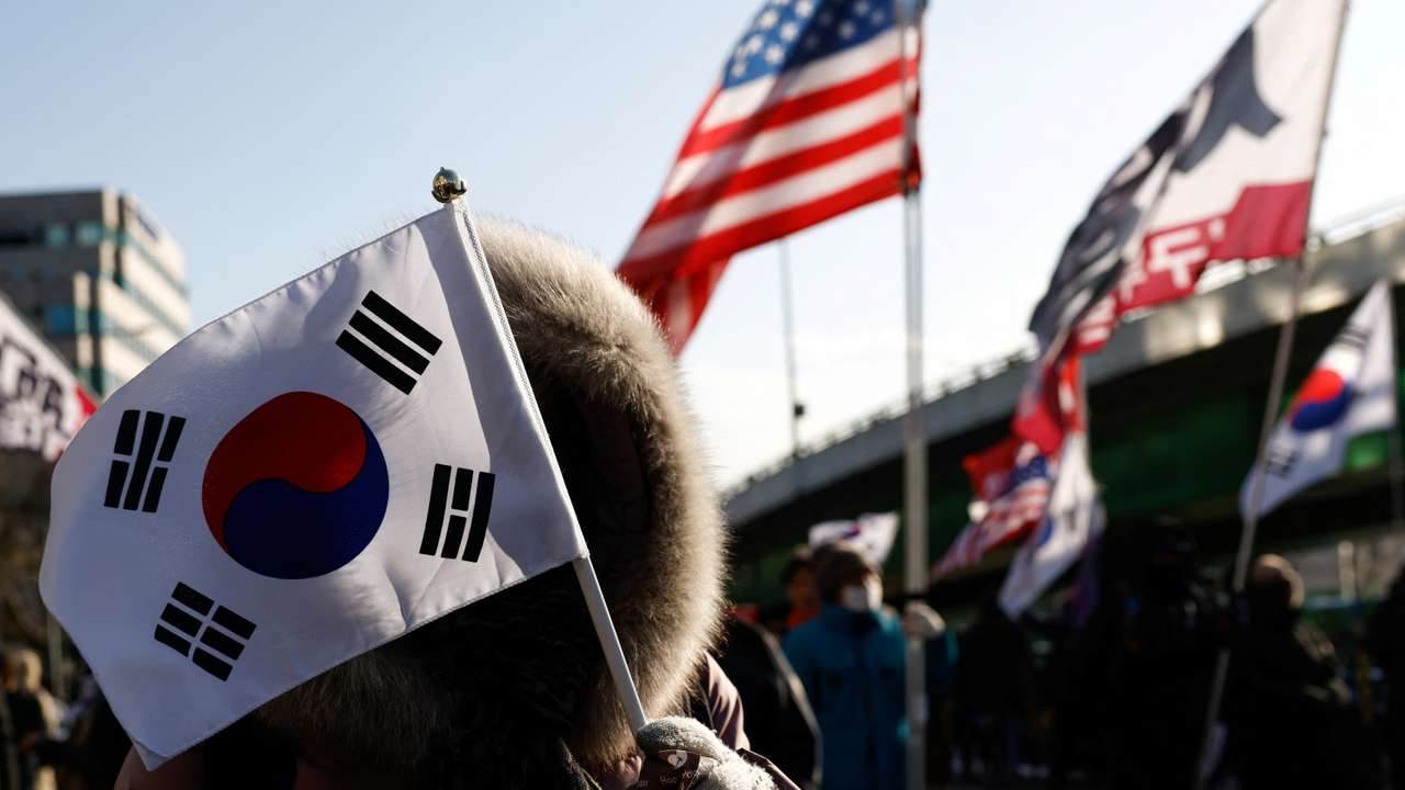 Pro-Yoon demonstrators hold U.S. and Korean flags as they take part in a rally in support of impeached South Korean President Yoon Suk Yeol near his official residence in Seoul