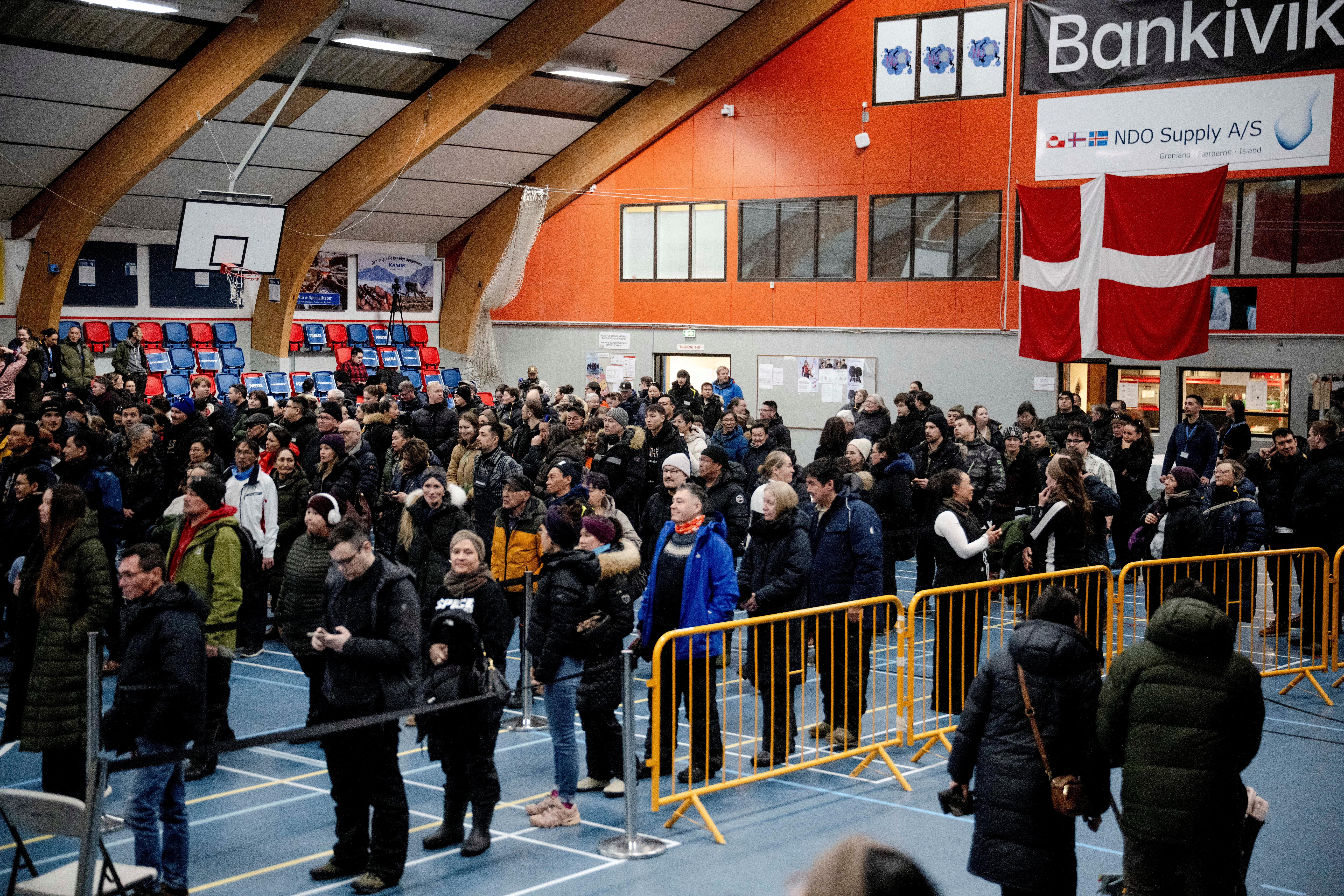 People stand at the polling station at the Godthabhallen, in Nuuk