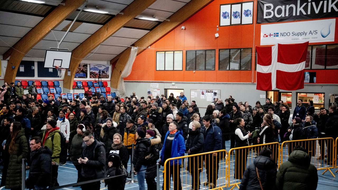 People stand at the polling station at the Godthabhallen, in Nuuk