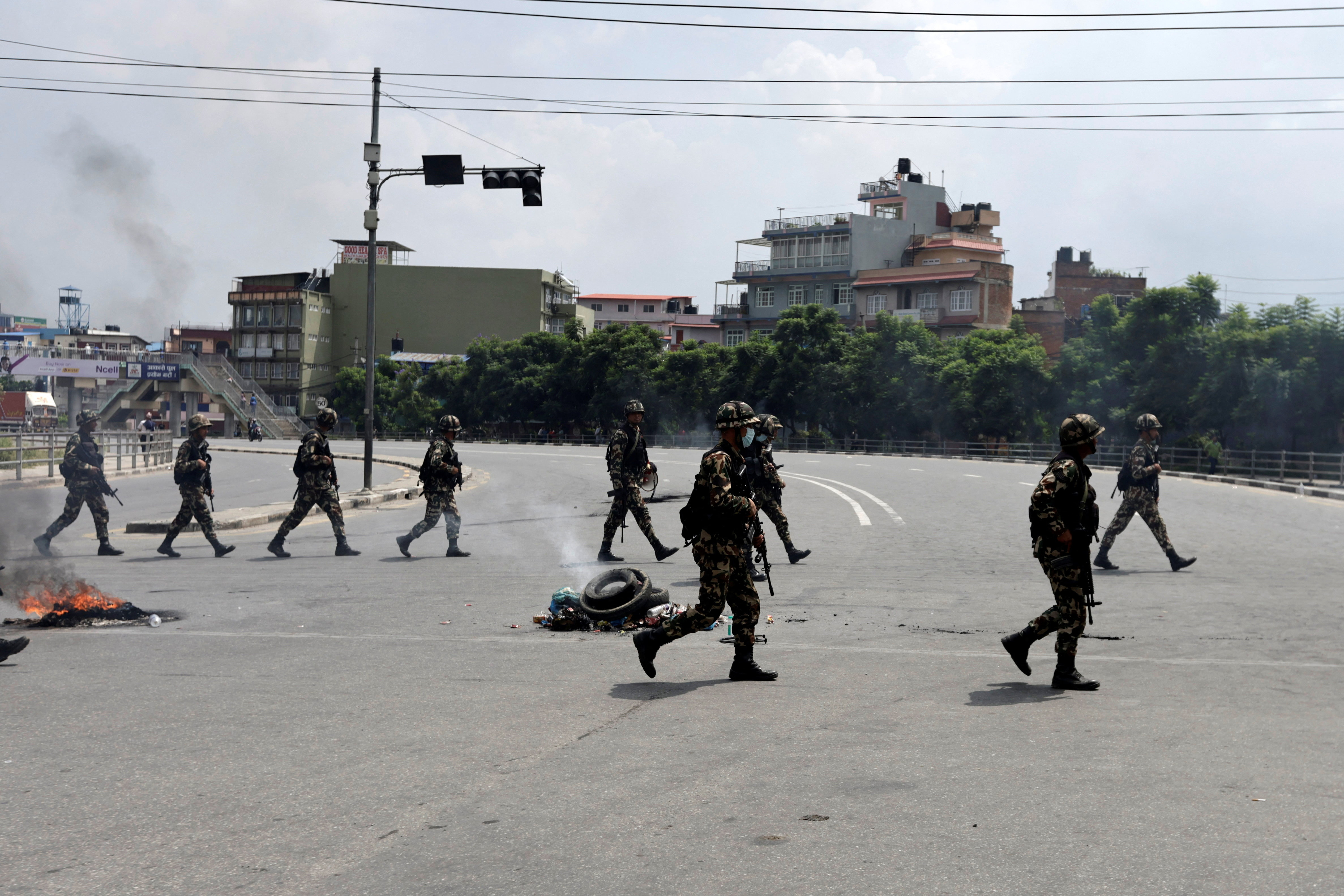Nepal Army soldiers patrol a road during a curfew, in Kathmandu