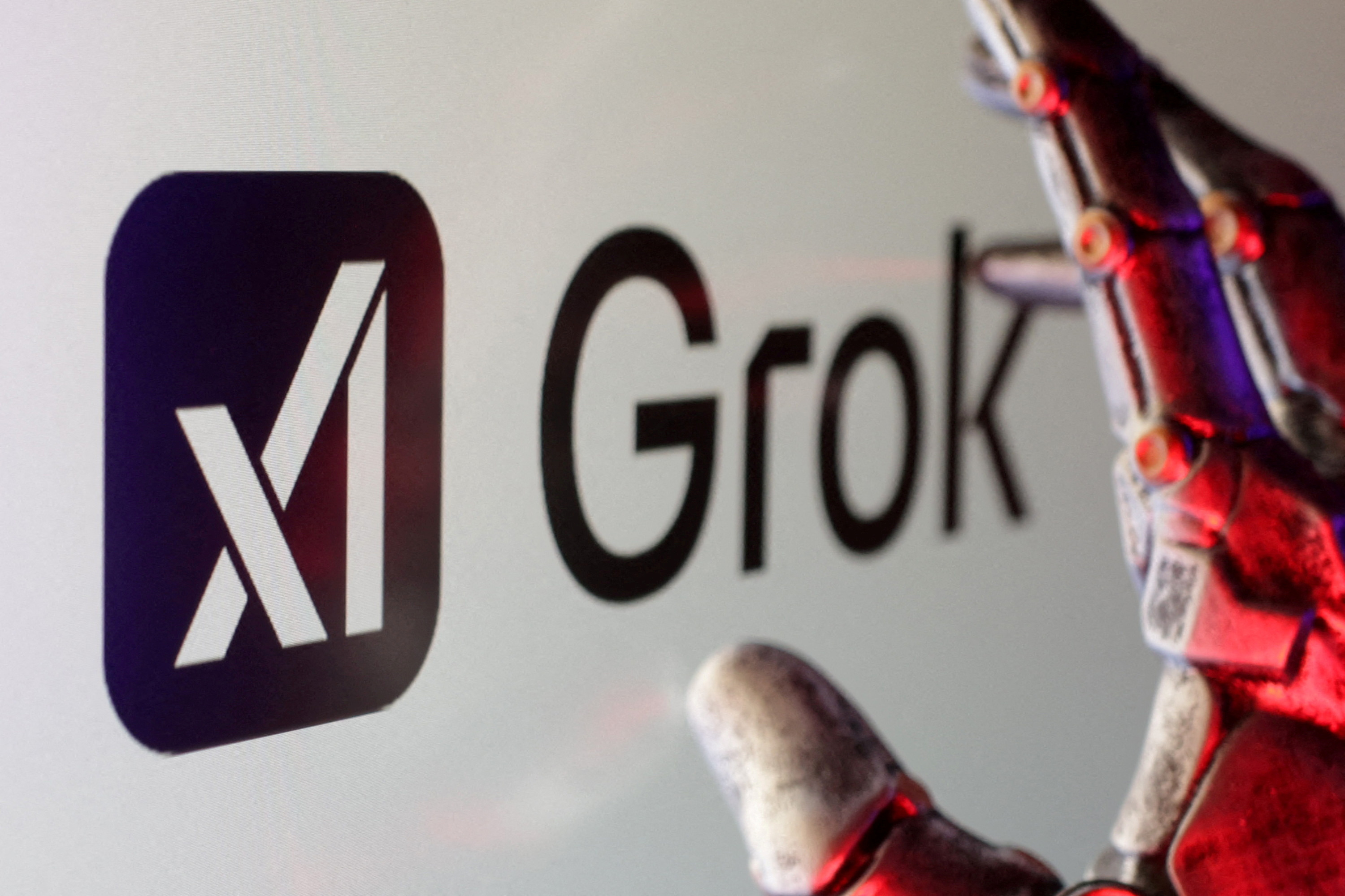 FILE PHOTO: Illustration shows xAI and Grok logos