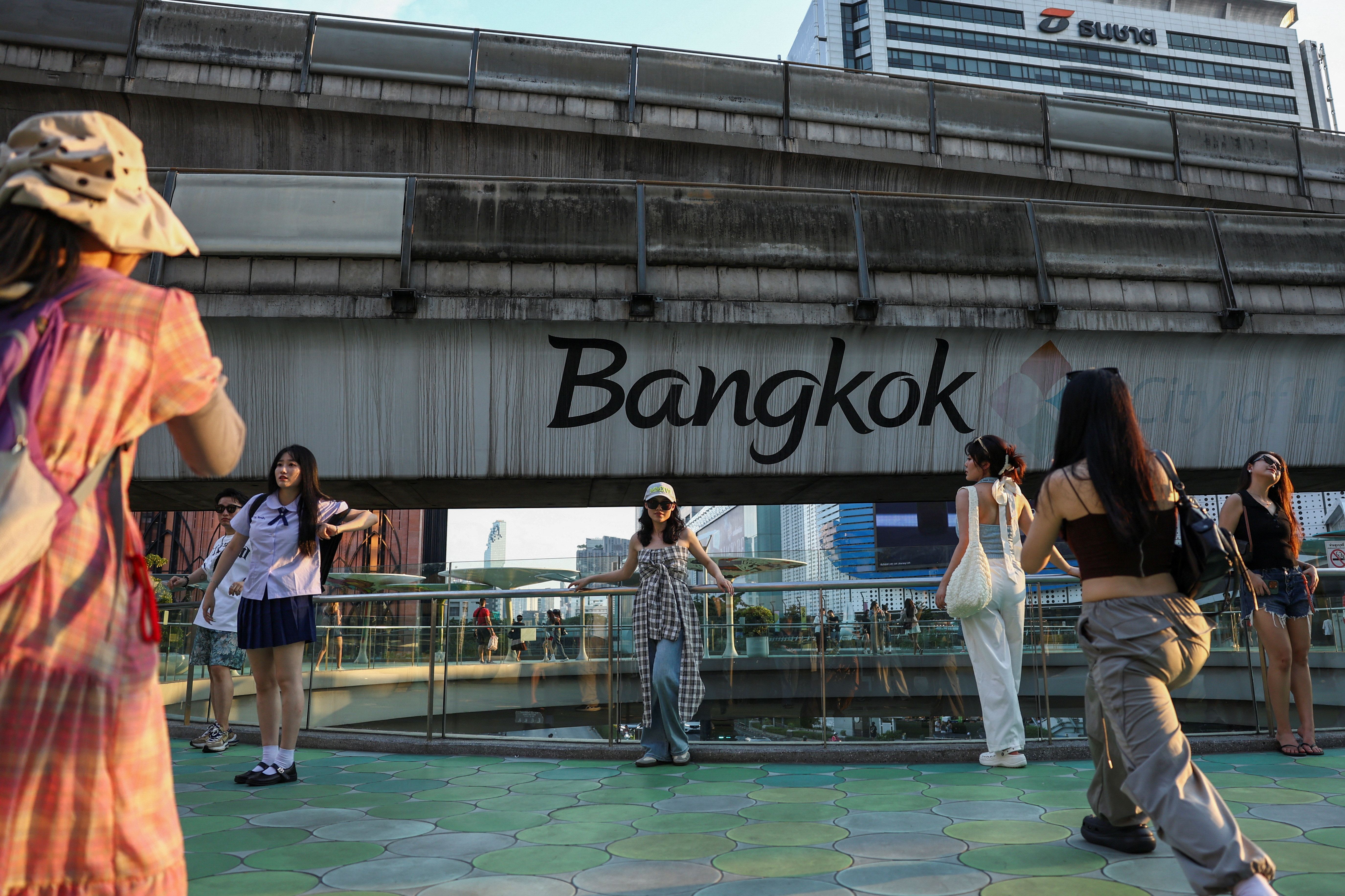 Chinese tourists take pictures in downtown as temperatures reached 39 degrees Celsius (102.2 Fahrenheit) in Bangkok