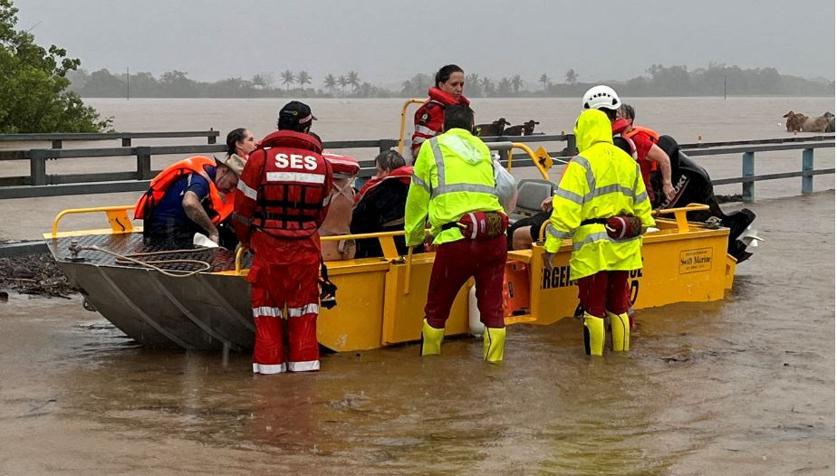 Emergency service personnel evacuate people in north Queensland after ex-tropical cyclone Jasper