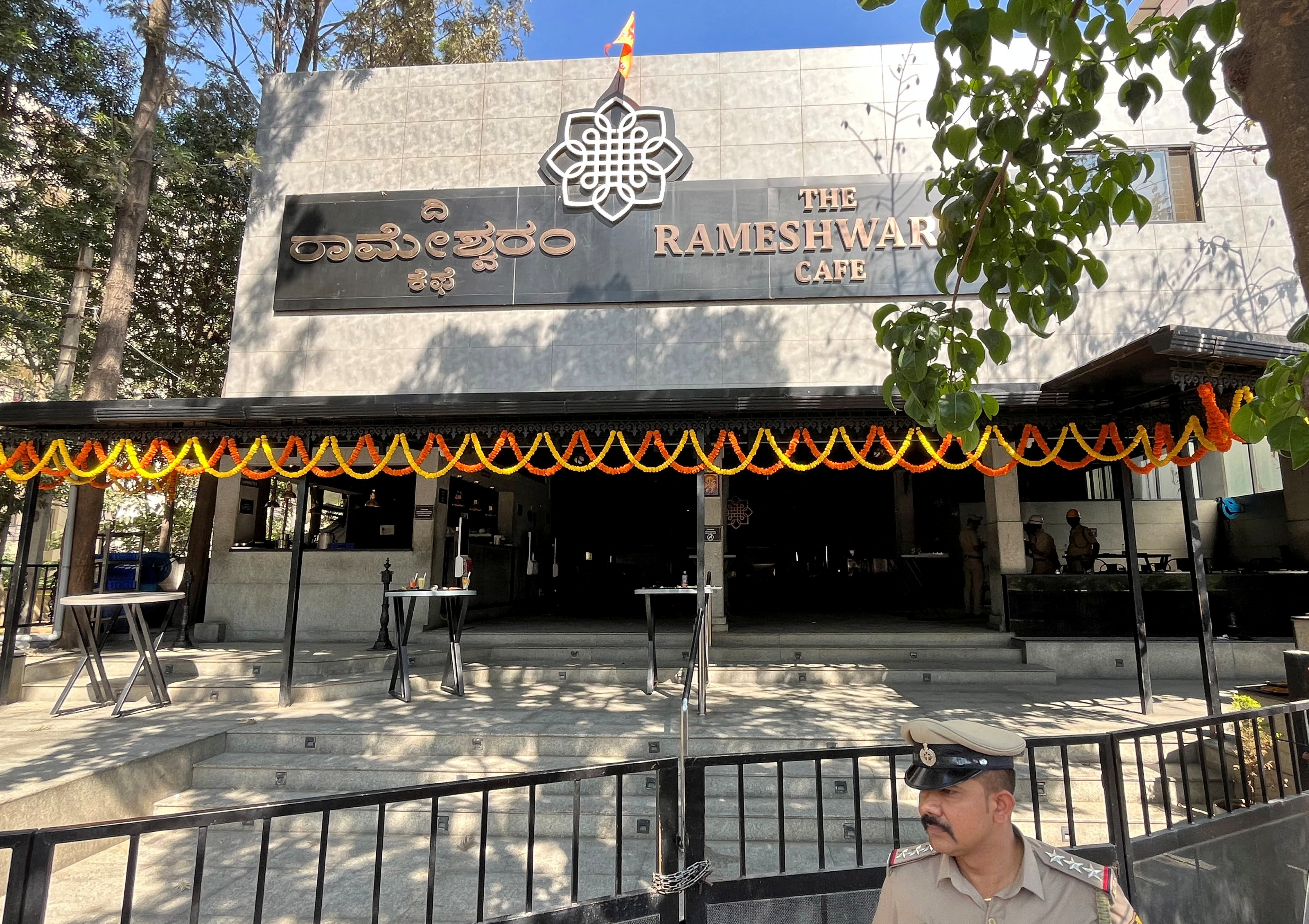 A police officer stands guard after a blast at a popular cafe in technology hub of Bengaluru