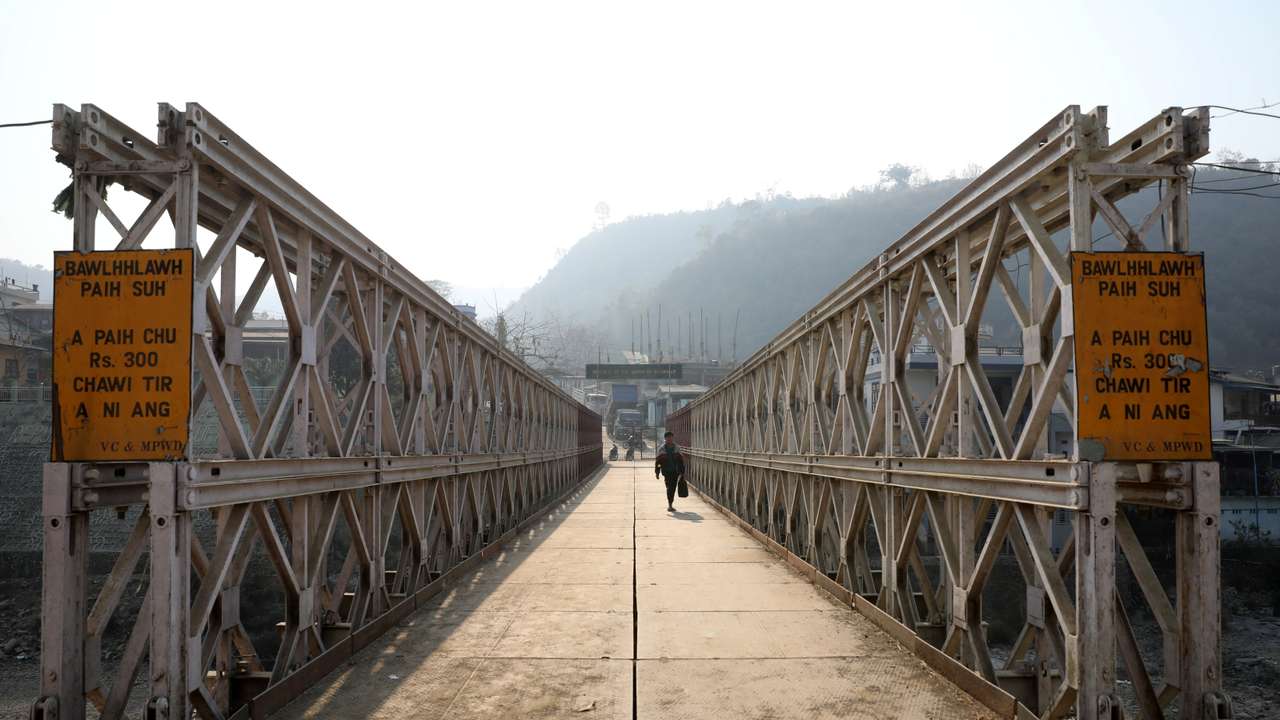 FILE PHOTO: A person walks on a bridge that connects Myanmar and India at the border village of Zokhawthar