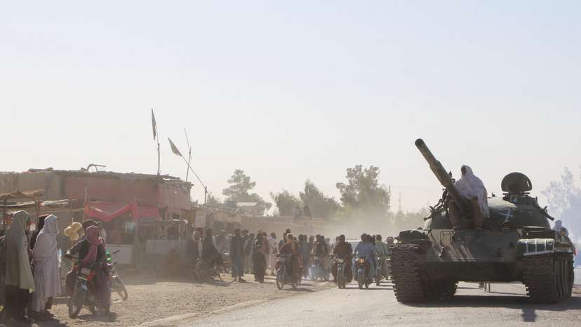 An Afghan Taliban fighter sits on a tank near the Afghanistan-Pakistan border in Spin Boldak, Kandahar Province, following exchanges of fire between Pakistani and Afghan forces