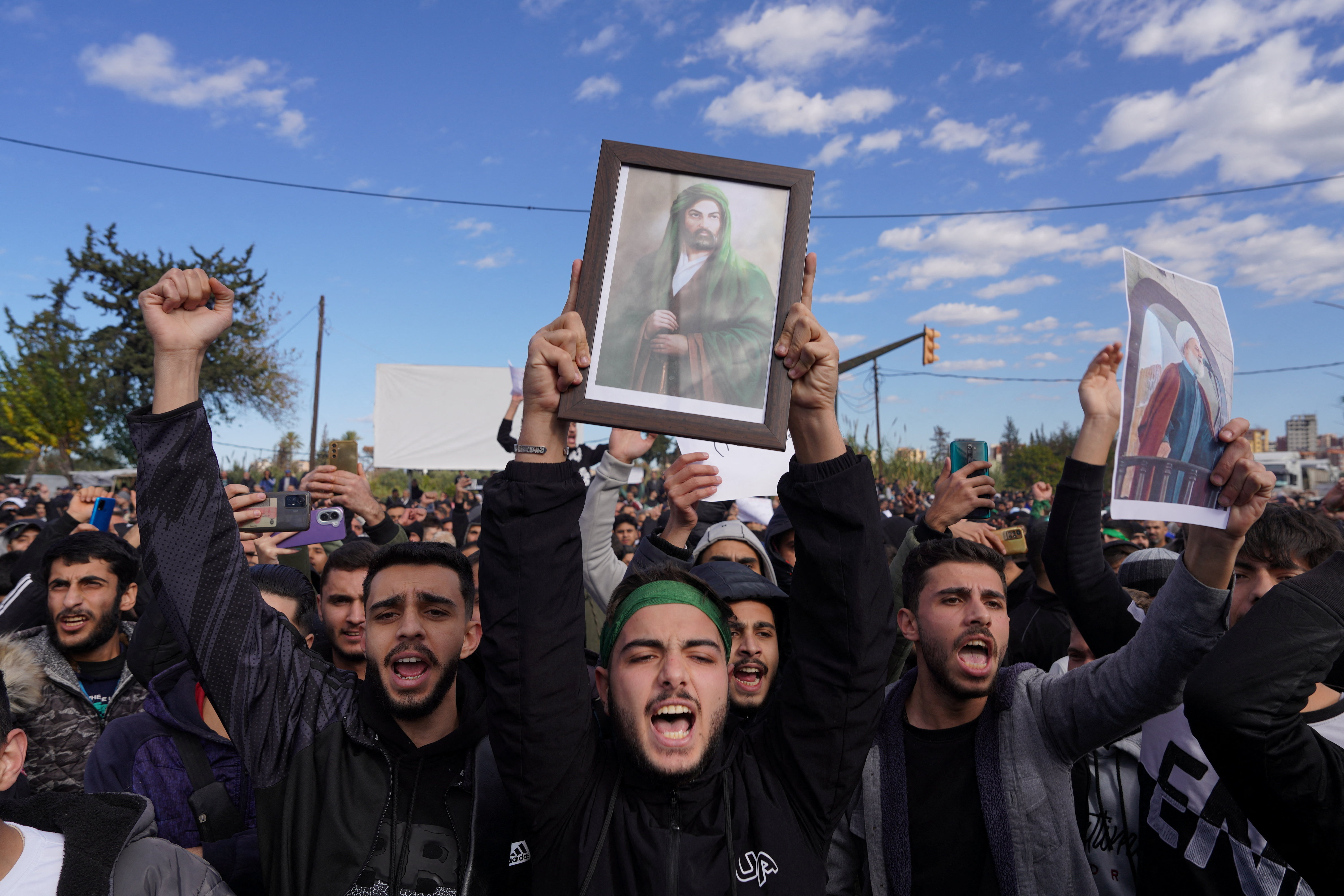 People from the Alawite sect protest as they demand federalism and an end to the killing and violations against Alawites, in Latakia