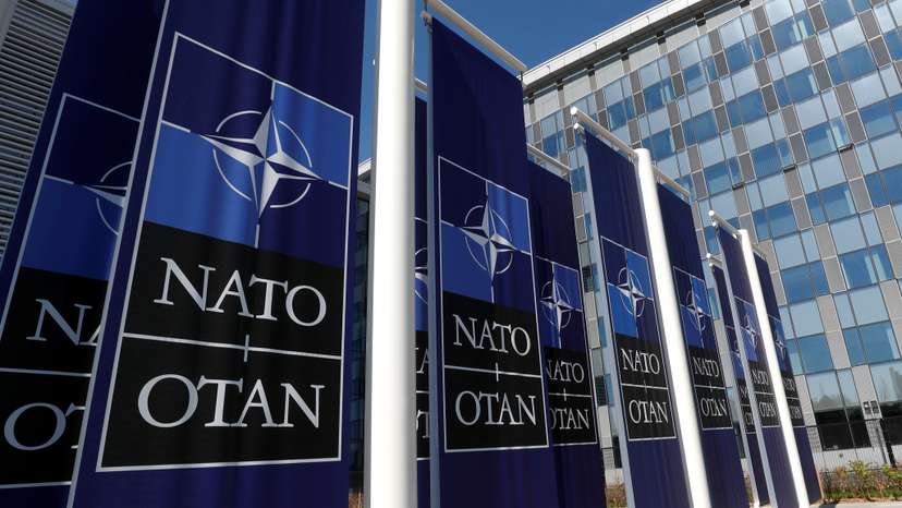 Banners displaying the NATO logo are placed at the entrance of new NATO headquarters during the move to the new building