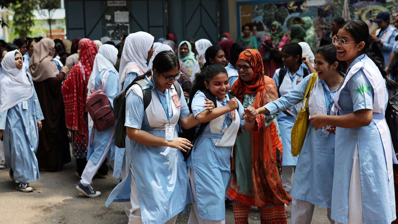 Students laugh as schools reopen after the fall in temperature, in Dhaka