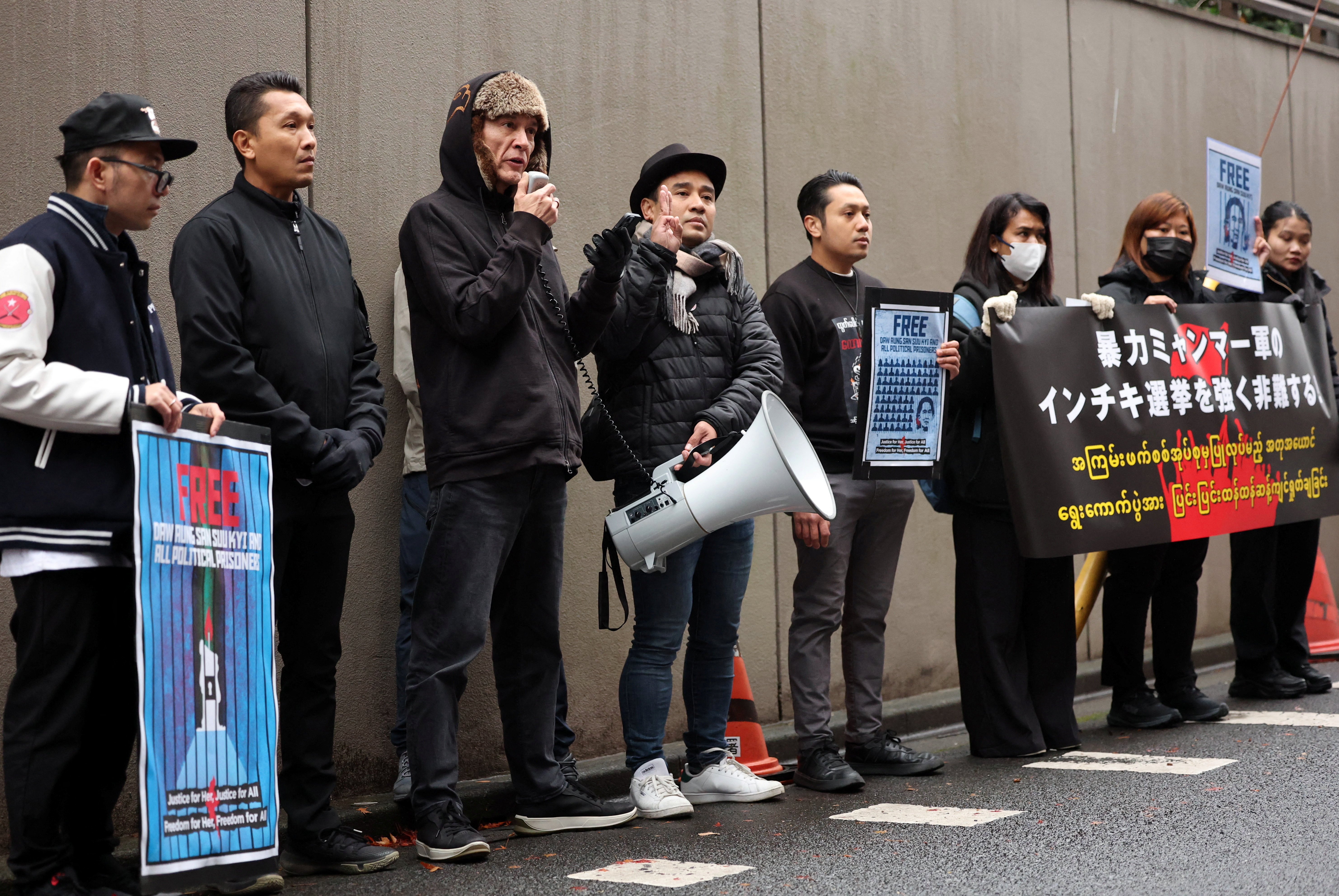 Kim Aris, the son of Aung San Suu Kyi, takes part in a protest rally denouncing an upcoming election in Tokyo