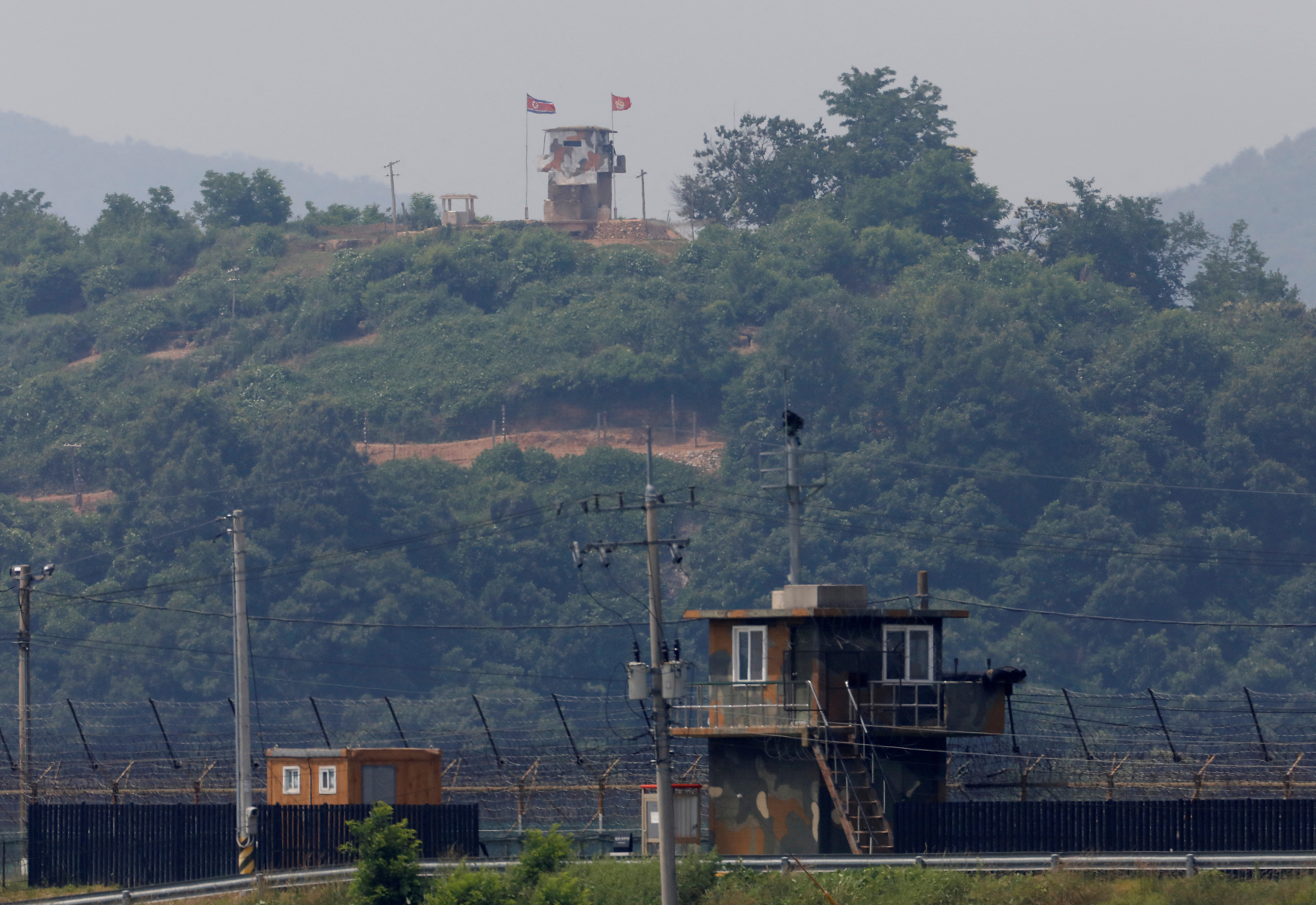 FILE PHOTO: A North Korean soldier stands guard at his guard post inside North Korean territory, in this picture taken from Paju, South Korea, near the demilitarized zone (DMZ) separating the two Koreas