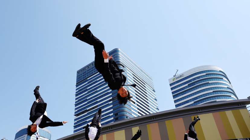 Japanese 'salarymen' cheerleaders in suits inspire with acrobatic stunts