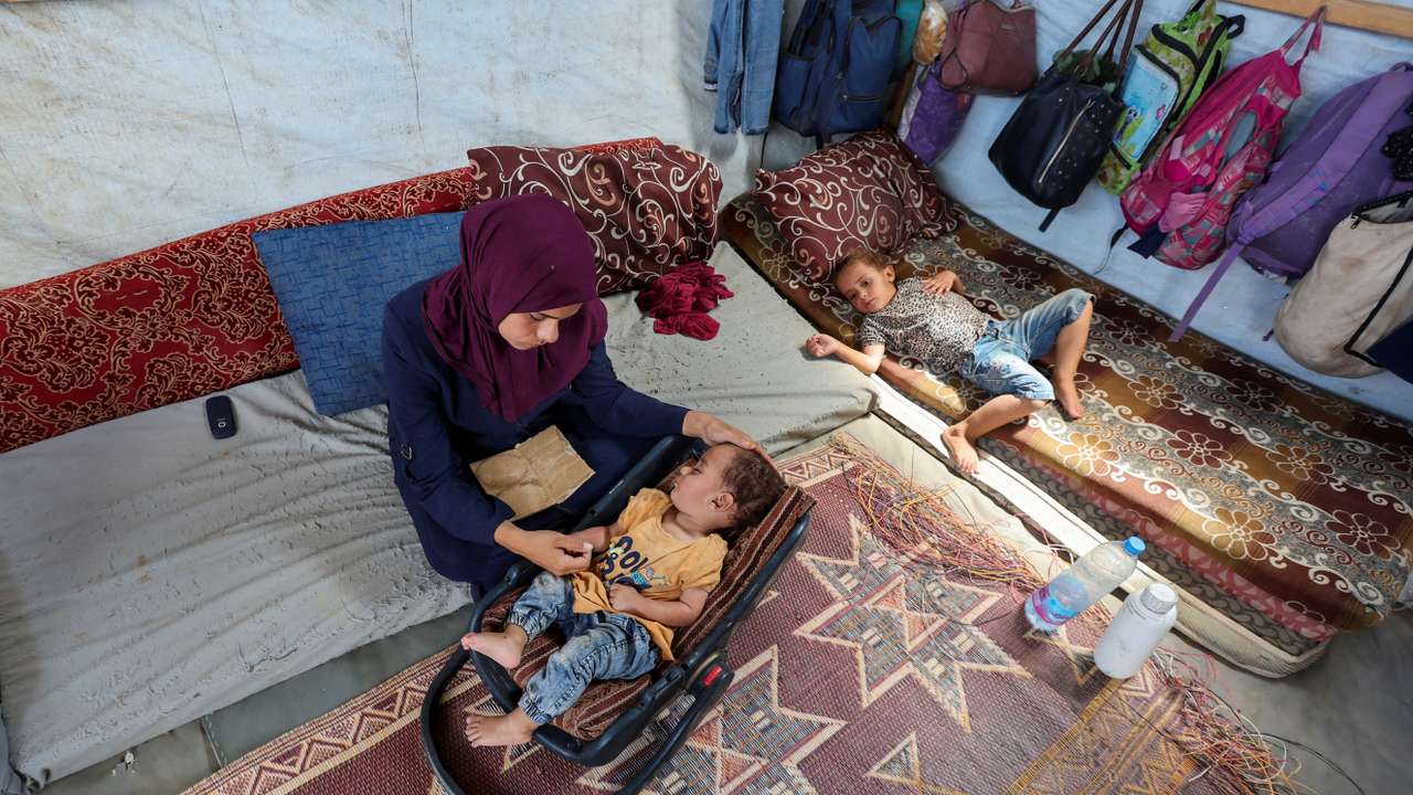 FILE PHOTO: The mother of Palestinian boy Abdul Rahman Abu Al-Jidyan, who is the first person to contract polio in Gaza in 25 years, looks after him in their tent, in Deir Al-Balah, in the central Gaza Strip
