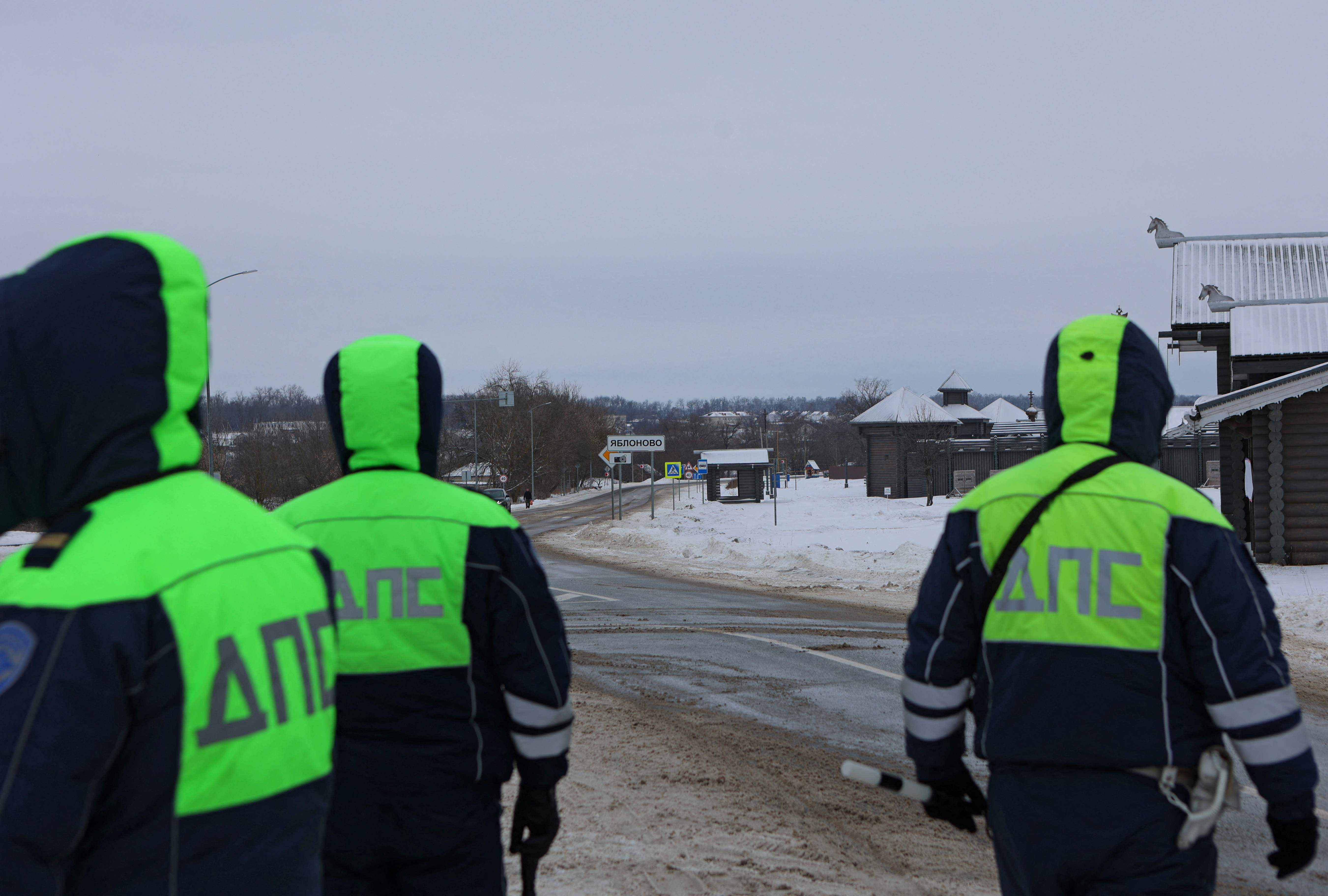 Traffic police officers block off a road near the crash site of the Russian Ilyushin Il-76 military transport plane in Belgorod Region