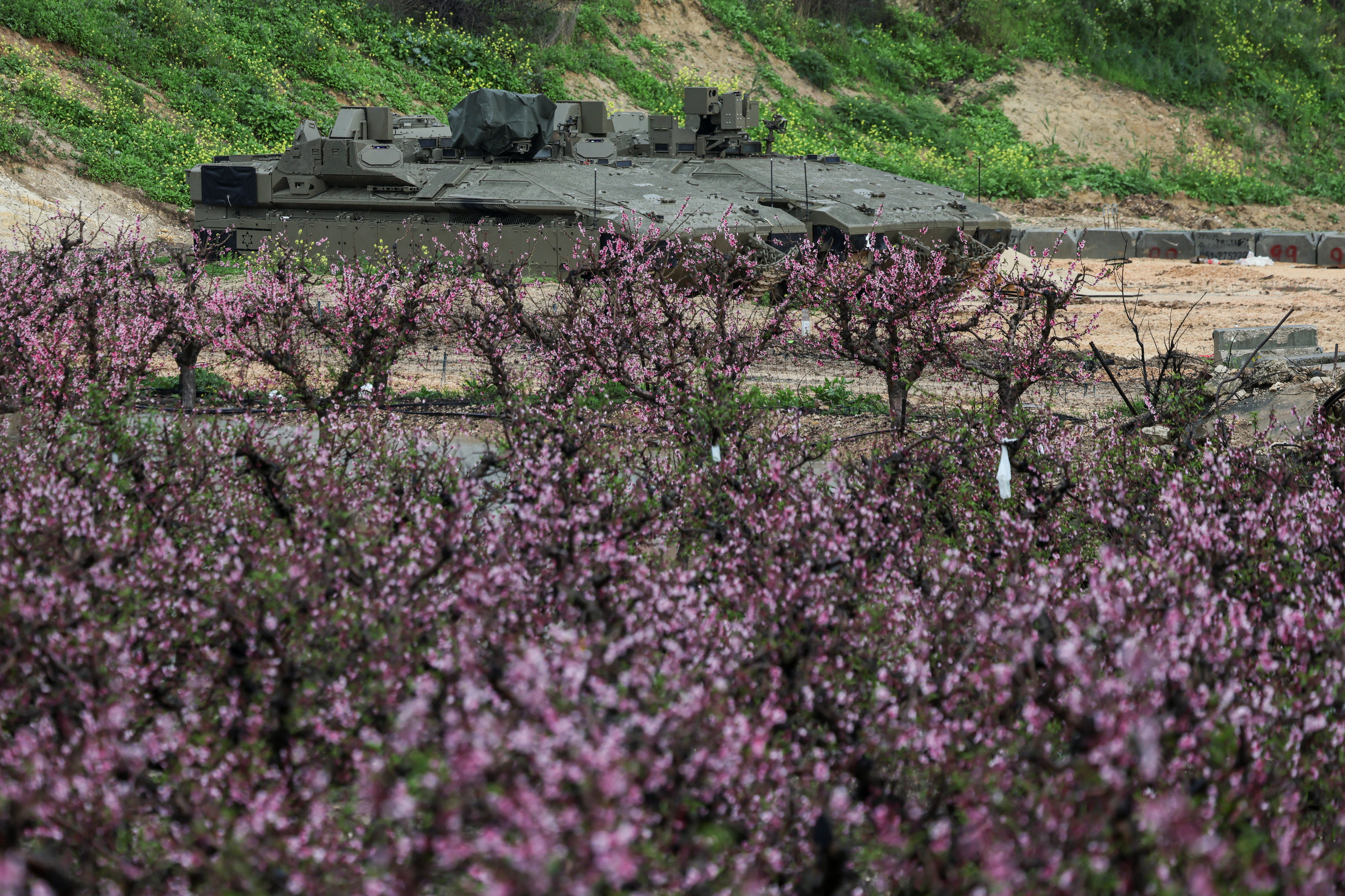 Israeli military vehicles are parked on the Israeli side of the border with Lebanon, amid escalation between Iran-backed Hezbollah and Israel and the U.S.-Israeli conflict with Iran