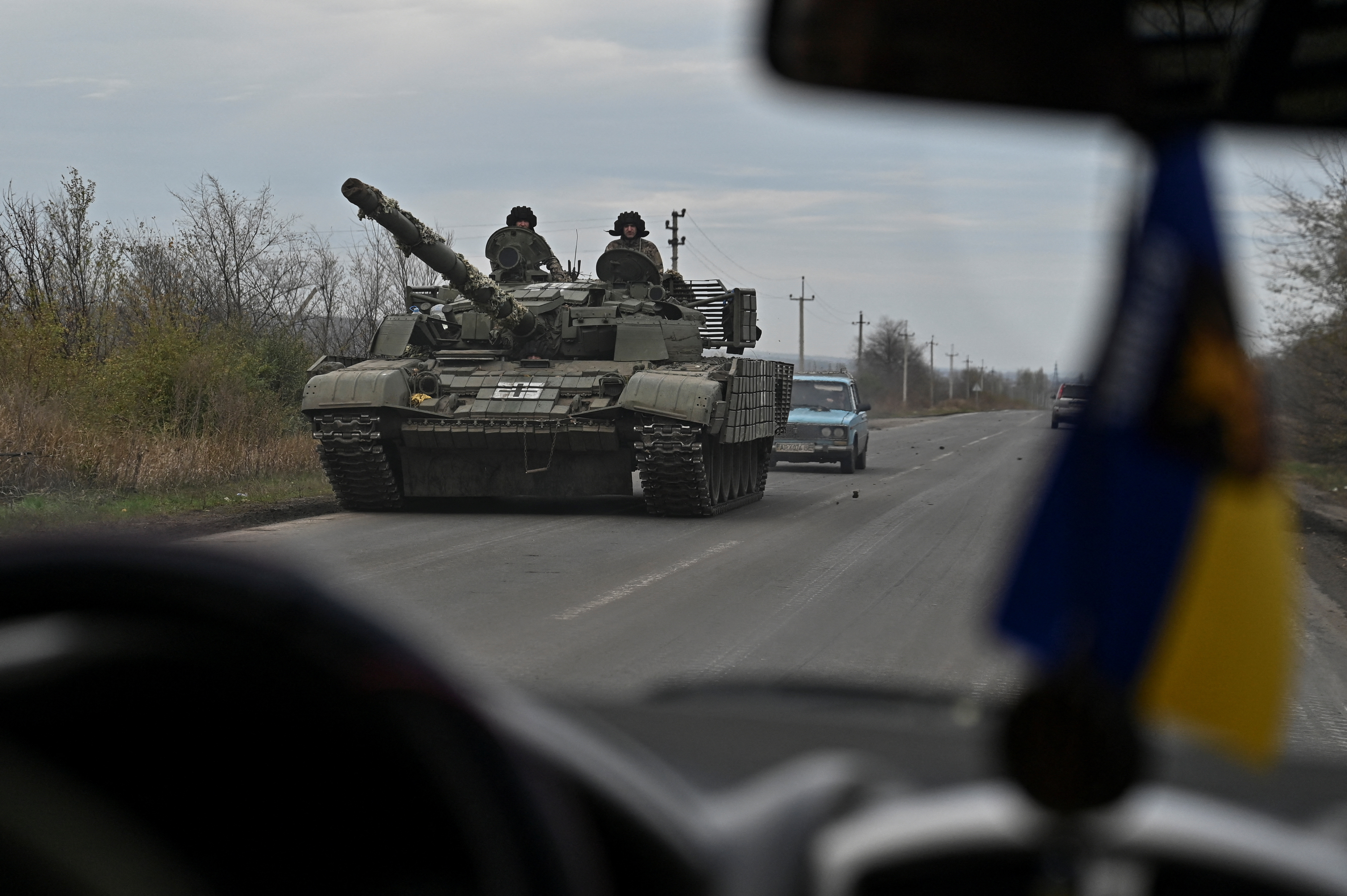 Ukrainian servicemen ride in a tank along a road near a frontline in Zaporizhzhia region