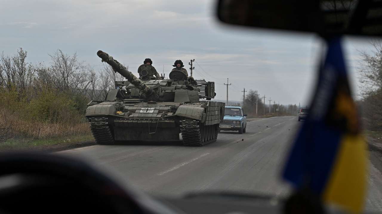 Ukrainian servicemen ride in a tank along a road near a frontline in Zaporizhzhia region