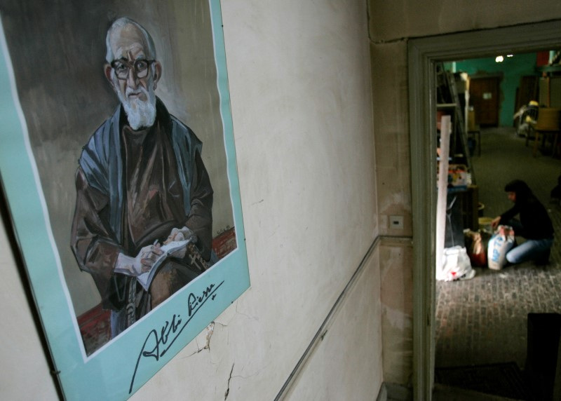 FILE PHOTO: A portrait of French priest Pierre hangs on a wall at La poudriere centre in Brussels