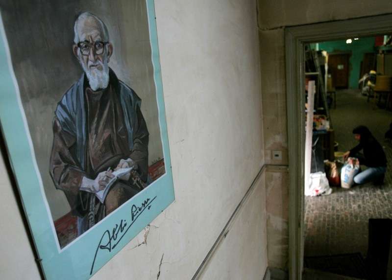 FILE PHOTO: A portrait of French priest Pierre hangs on a wall at La poudriere centre in Brussels