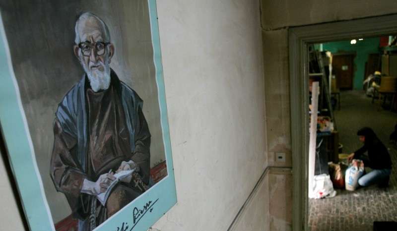 FILE PHOTO: A portrait of French priest Pierre hangs on a wall at La poudriere centre in Brussels