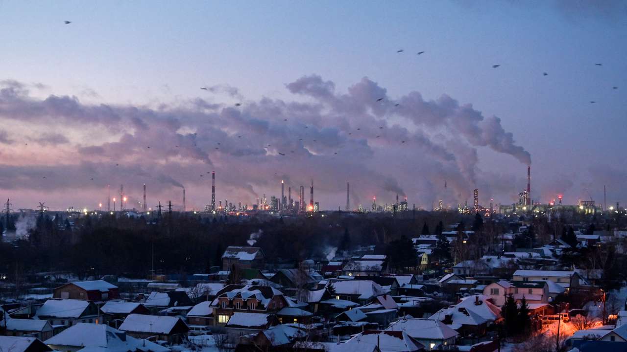 FILE PHOTO: Flue gas and steam rise out of chimneys in Omsk