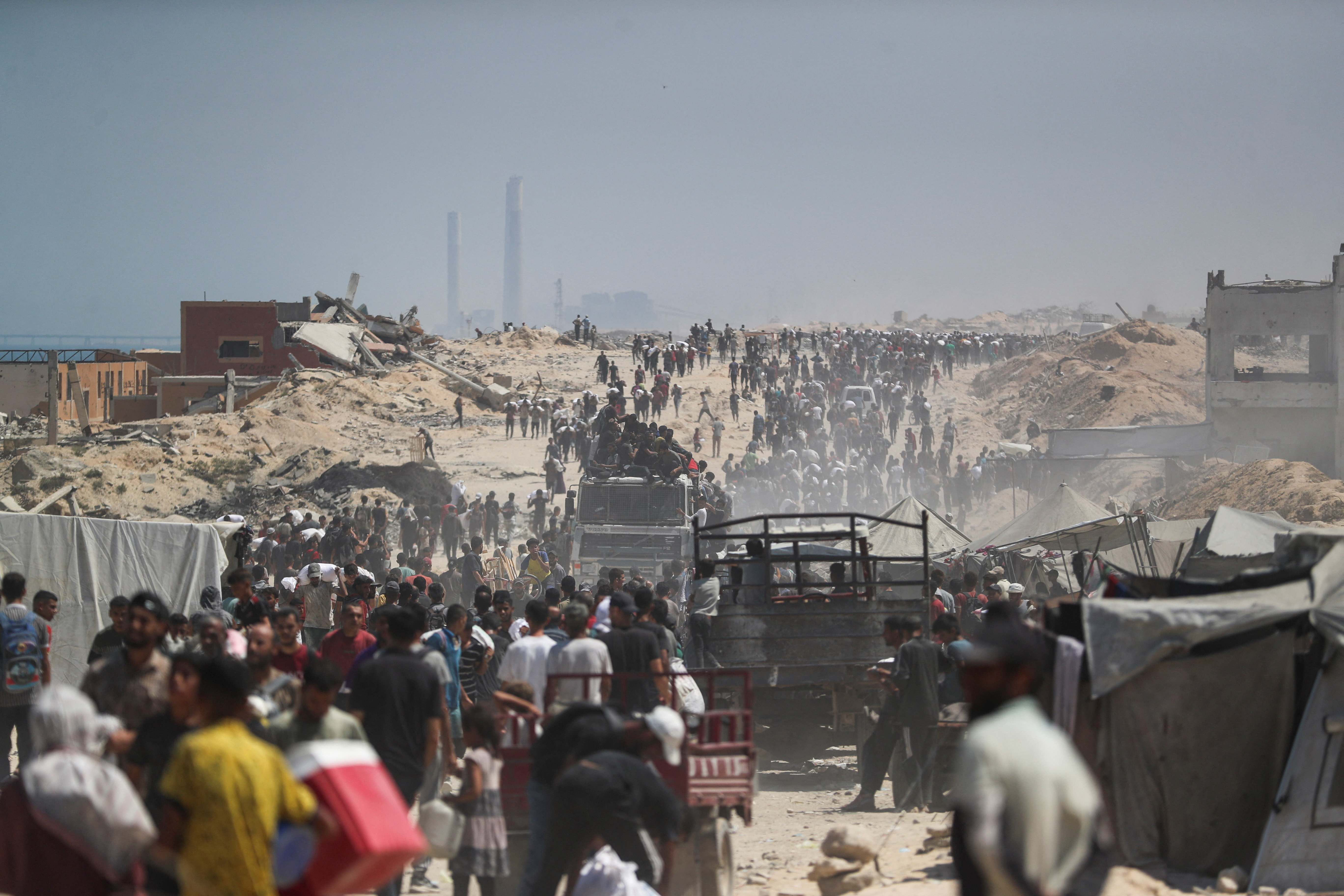 Palestinians carry aid supplies that entered Gaza through Israel, in Beit Lahia