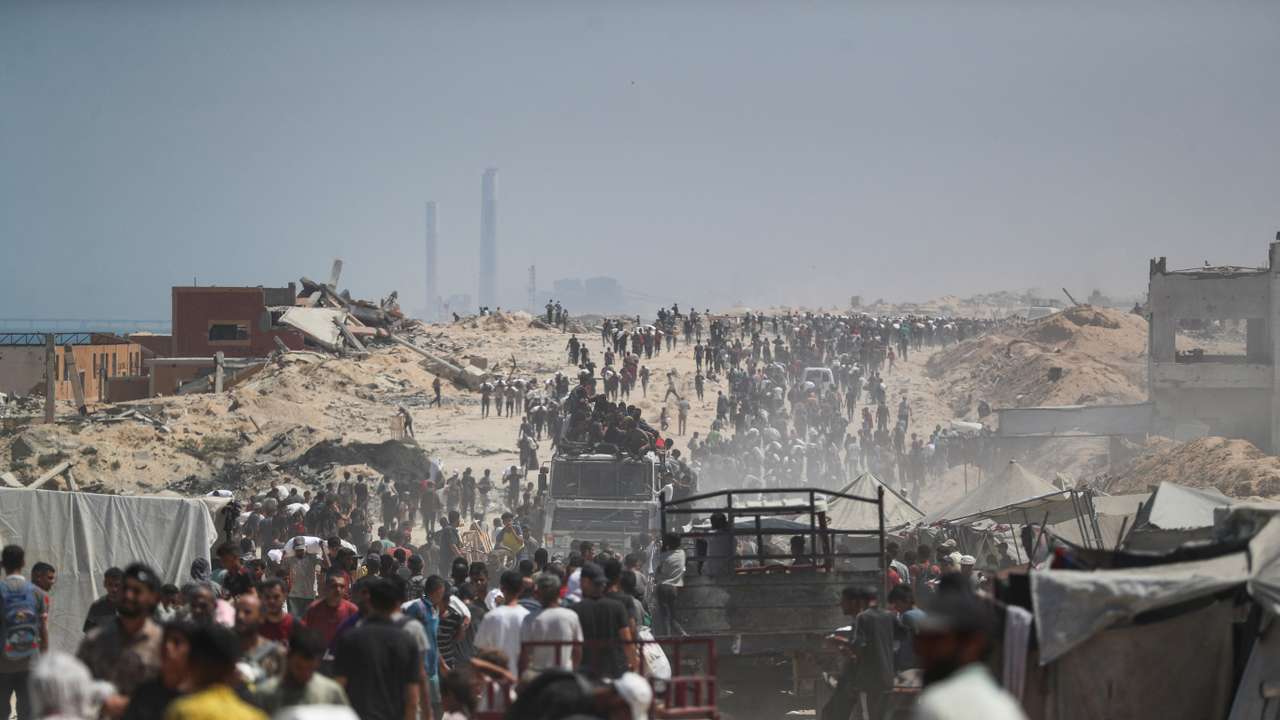 Palestinians carry aid supplies that entered Gaza through Israel, in Beit Lahia