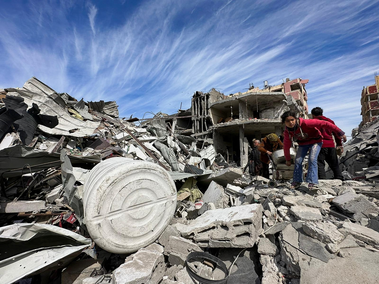 Residents inspect damages caused to Zeitoun neighborhood, in Gaza City