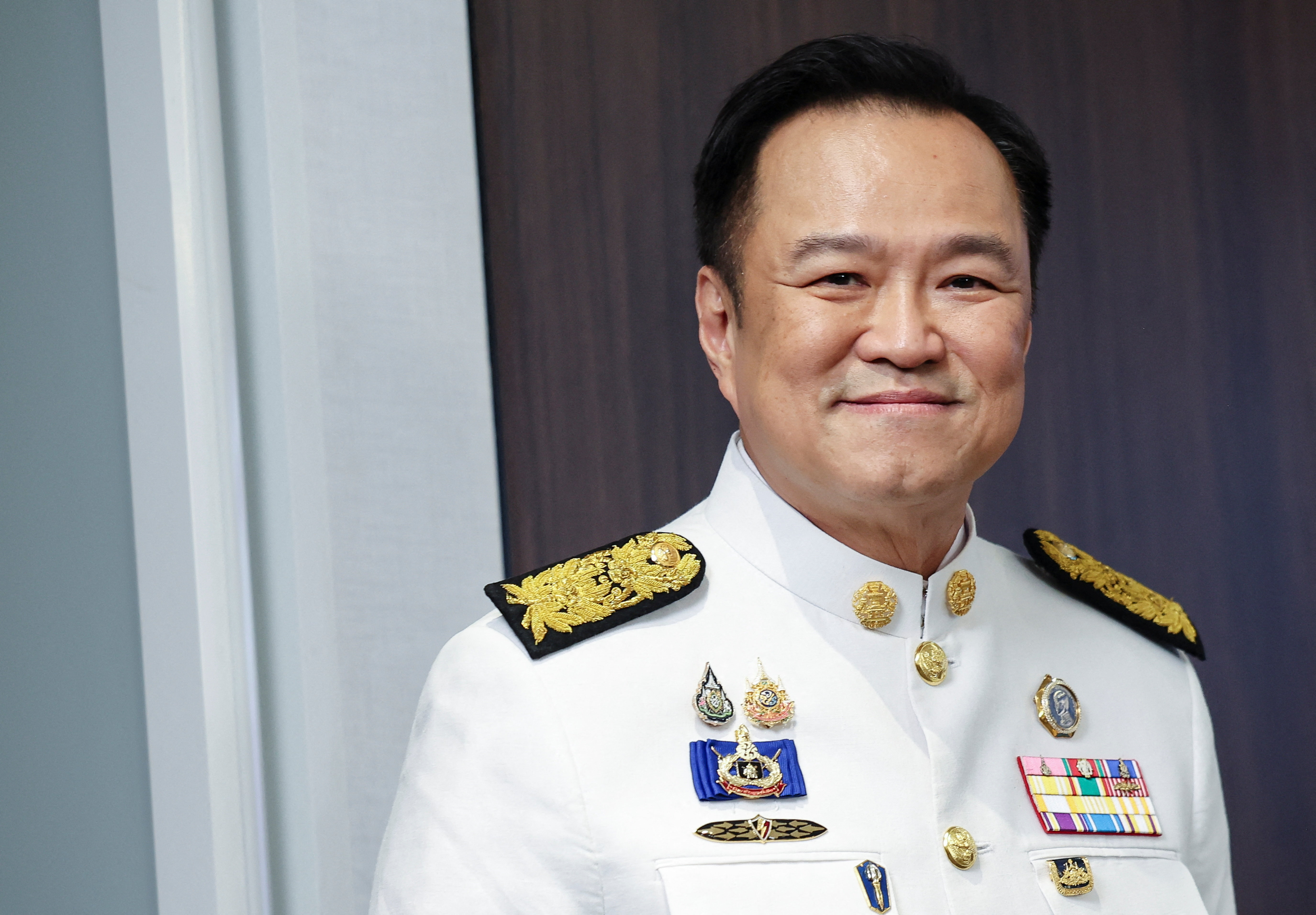 FILE PHOTO: Thailand's Prime Minister Anutin Charnvirakul smiles as he attends a press conference at the Bhumjaithai party headquarters after a royal endorsement ceremony in Bangkok