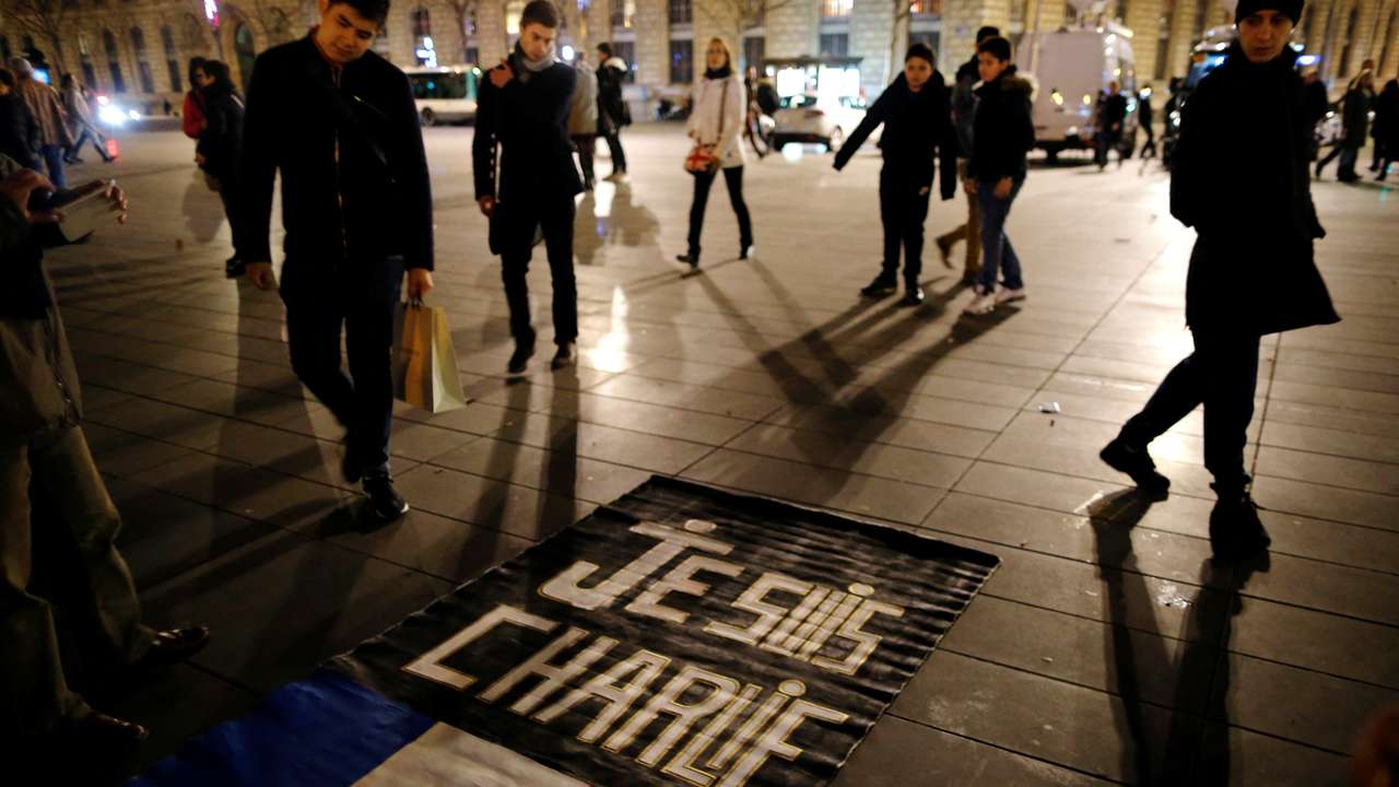 FILE PHOTO: People gather on the Place de la Republique square to pay tribute to the victims of last year's shooting at the French satirical newspaper Charlie Hebdo in Paris