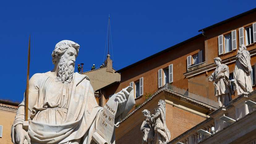 Firefighters work to set a chimney on the roof of the Sistine Chapel, ahead of the conclave, at the Vatican