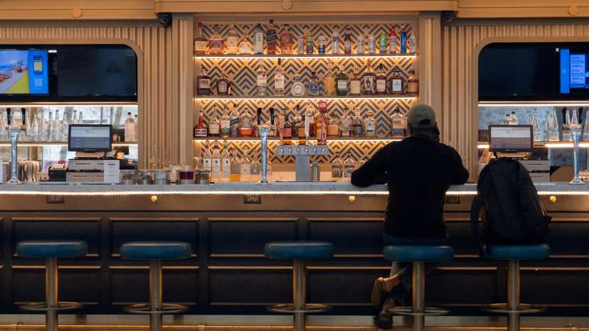 FILE PHOTO: A man sits at a bar in LaGuardia Airport in New York
