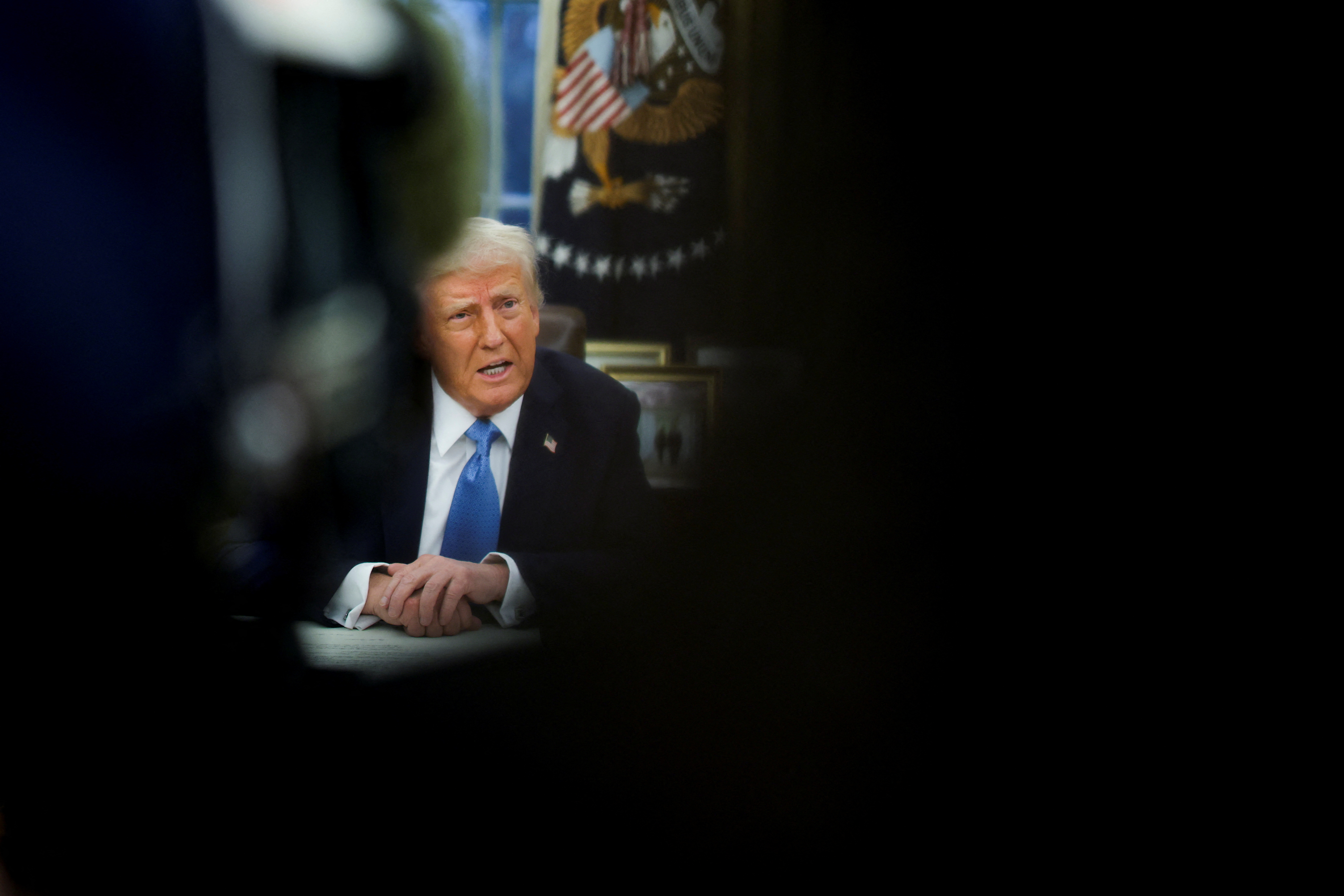 U.S. President Donald Trump signs an executive order in the Oval Office at the White House
