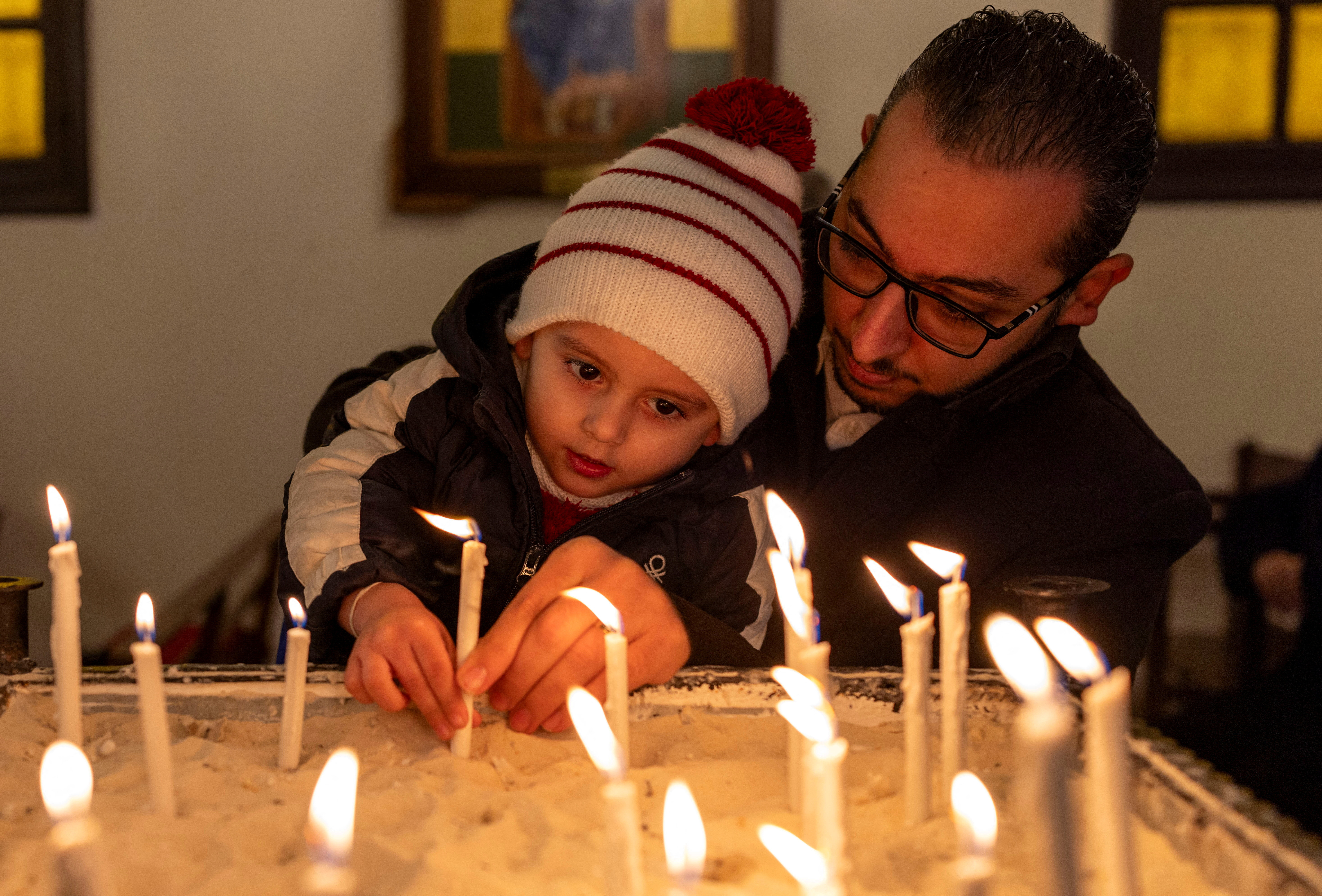 Members of Orthodox community of Latakia attend a Sunday Mass in Syria's coastal city