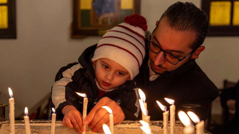 Members of Orthodox community of Latakia attend a Sunday Mass in Syria's coastal city