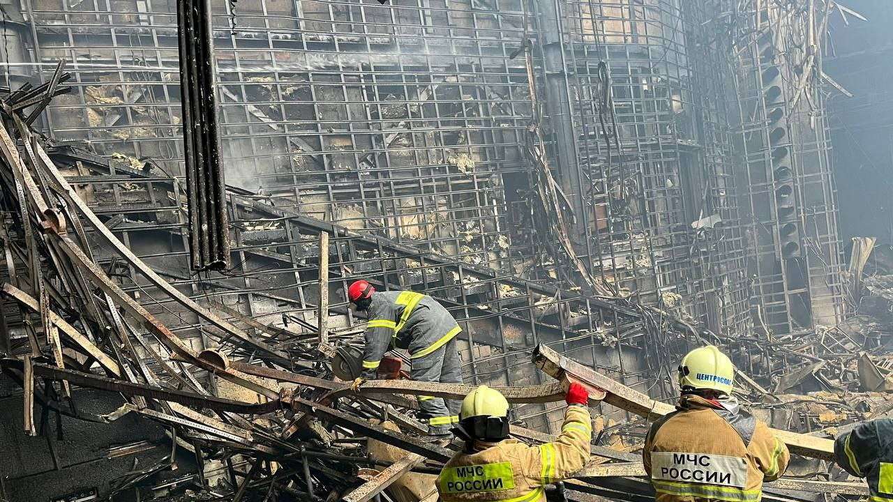 Members of the Russian Emergencies Ministry clear rubble at the Crocus City Hall concert venue after a deadly attack, outside Moscow
