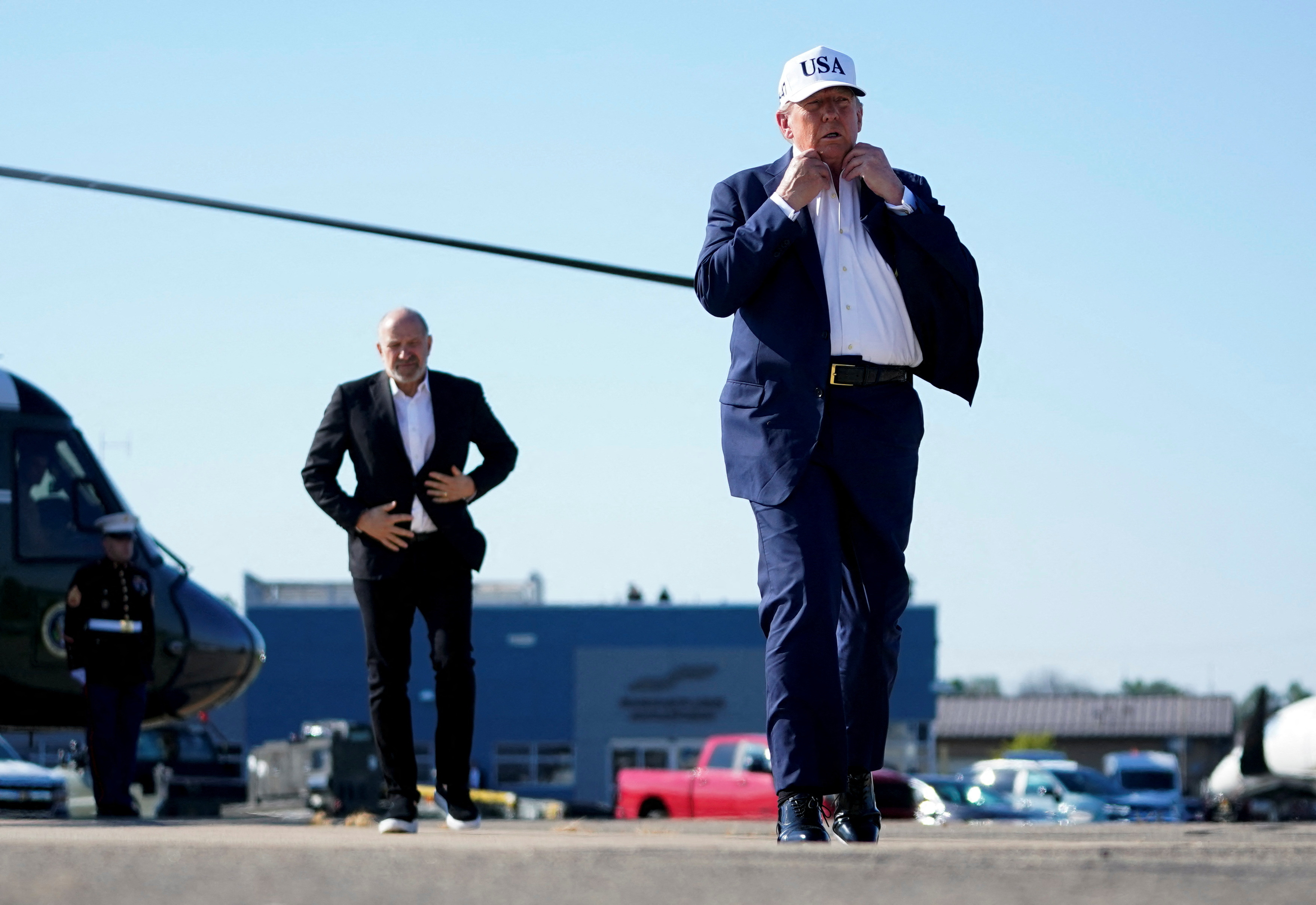U.S. President Donald Trump and U.S. Secretary of Commerce Howard Lutnick walk at Morristown Airport
