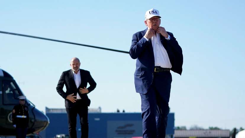 U.S. President Donald Trump and U.S. Secretary of Commerce Howard Lutnick walk at Morristown Airport