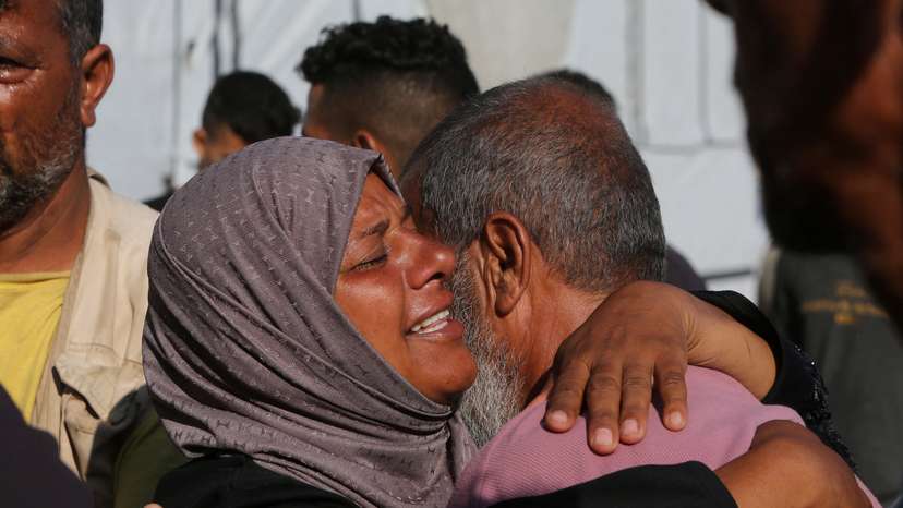 People mourn Palestinians who were killed in an incident while seeking aid in Khan Younis, at Nasser hospital in Khan Younis