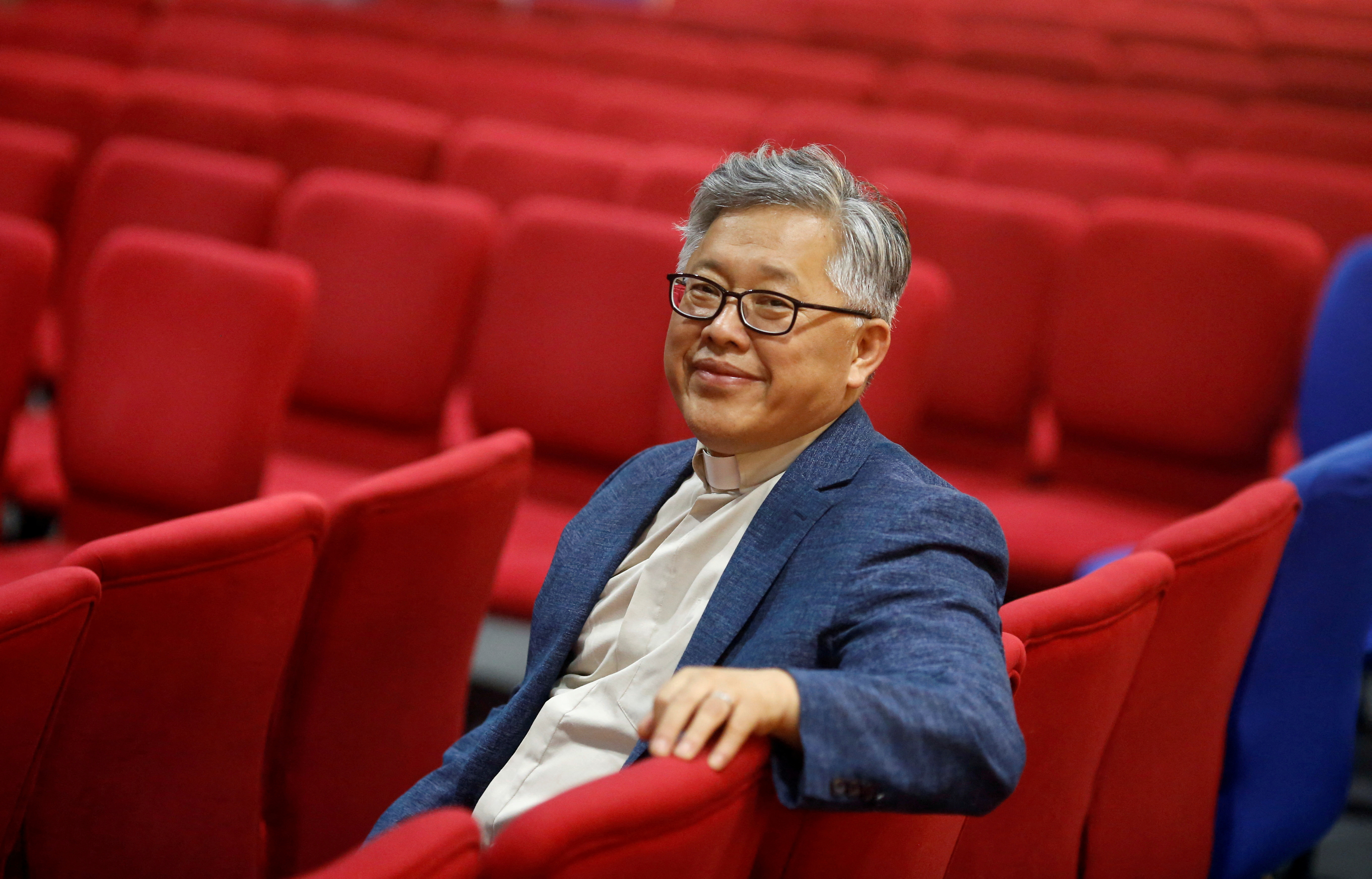 FILE PHOTO: The head pastor of the Zion church in Beijing Jin Mingri poses for picures in the congregation hall of the unofficial Protestant "house" church in Beijing