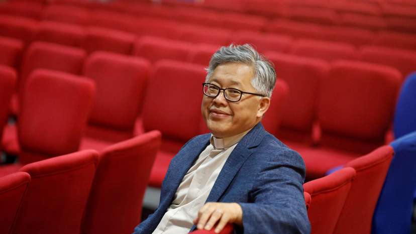 FILE PHOTO: The head pastor of the Zion church in Beijing Jin Mingri poses for picures in the congregation hall of the unofficial Protestant "house" church in Beijing