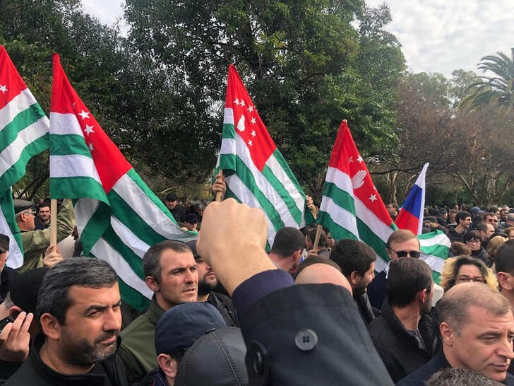 FILE PHOTO: Protesters rally outside the parliament building in the capital of Georgia's breakaway region of Abkhazia
